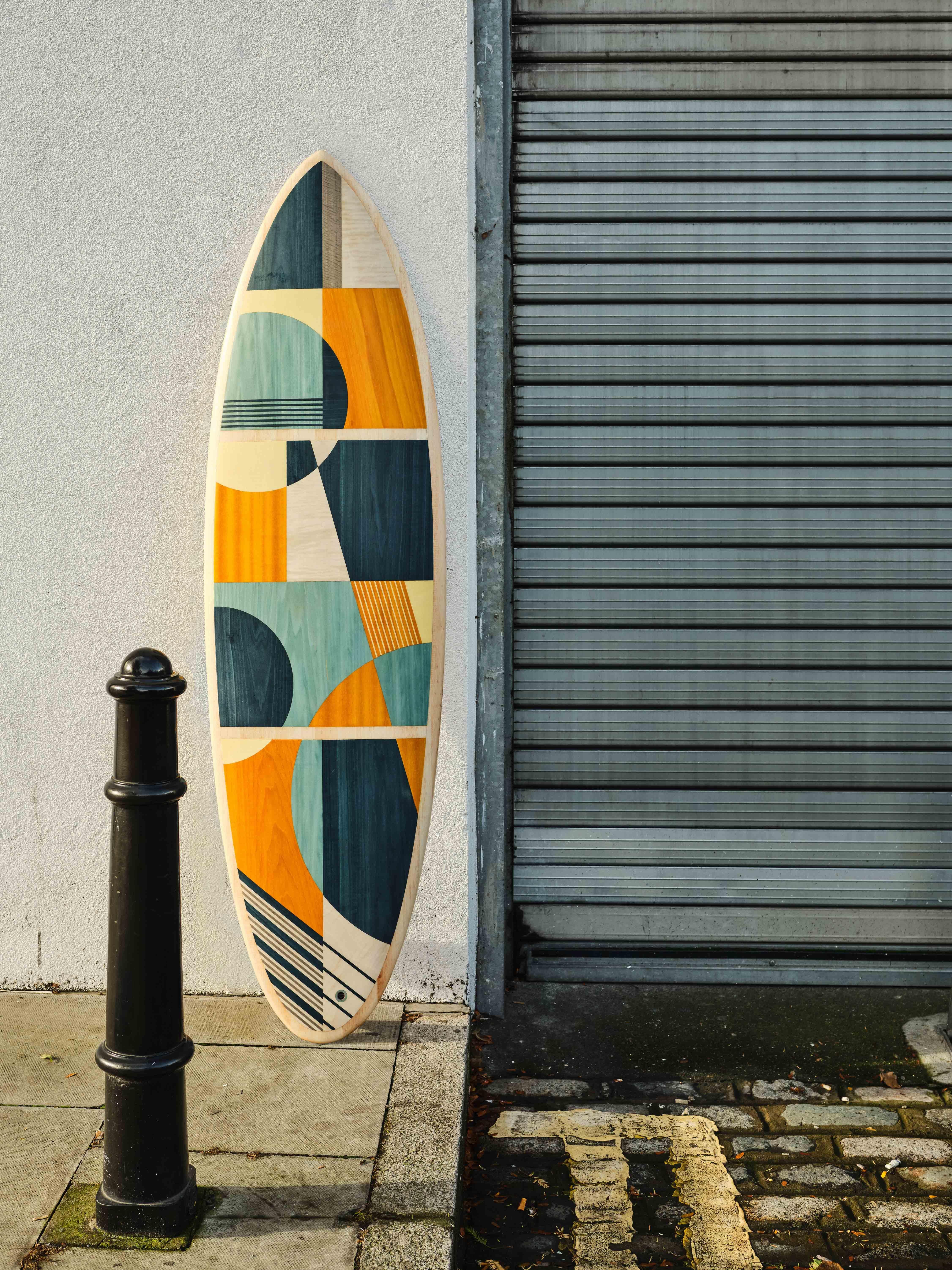 This is a unique custom surfboard featuring a marquetry deck, designed and hand-crafted by the w o o d p o p studio which specialises in marquetry and inlay work. 

The studio prides itself on constantly challenging the limits of where and how