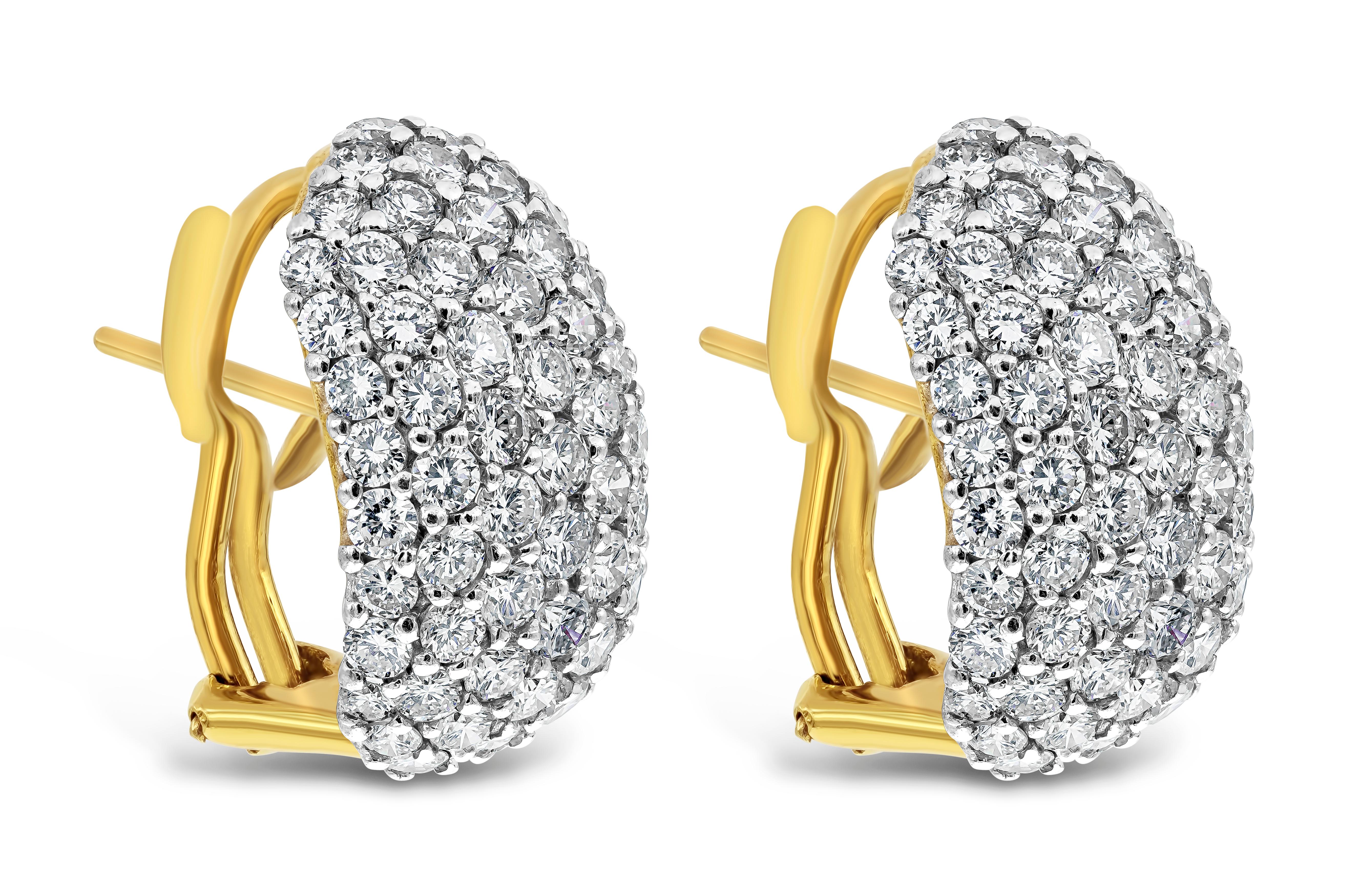 A brilliant and simple style earrings showcasing a cluster of brilliant round diamonds weighing 6.49 carats total, G-H Color, VS in clarity. Micro-pave set in a oval dome made in 18k yellow gold. Omega-clip backs with post.

Style available in