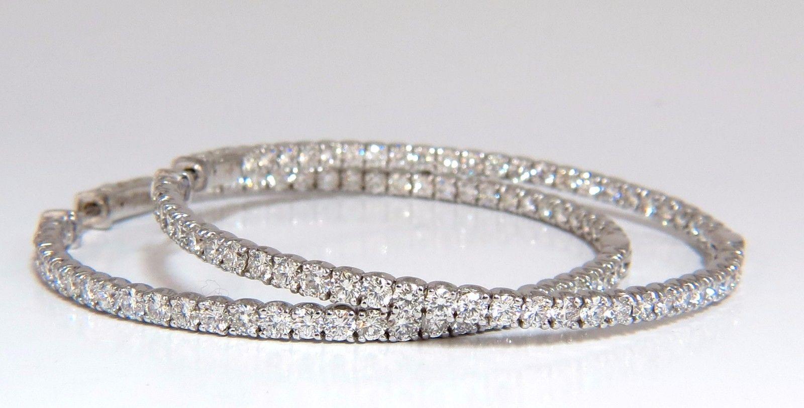 Large Modern, In & Out.

 6.40ct. Natural Round, Brilliant diamonds hoop earrings.

G color, VS-2 clarity

Full cuts, great sparkle.

2.2 inch in diameter 

3 mm wide diamond row

 18 grams.

14kt. white gold. 

Button press Locking & open

$21,000