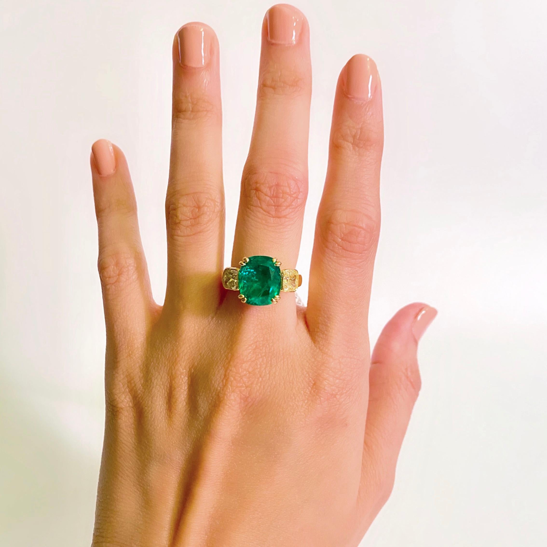 The Emerald features a natural Ethiopian emerald of a vibrant green hue and a slight yellow overtone, set in an 18K yellow gold mounting. This emerald is complemented by a pair of matching fancy yellow diamonds. 

Gemstone Details
Natural Ethiopian