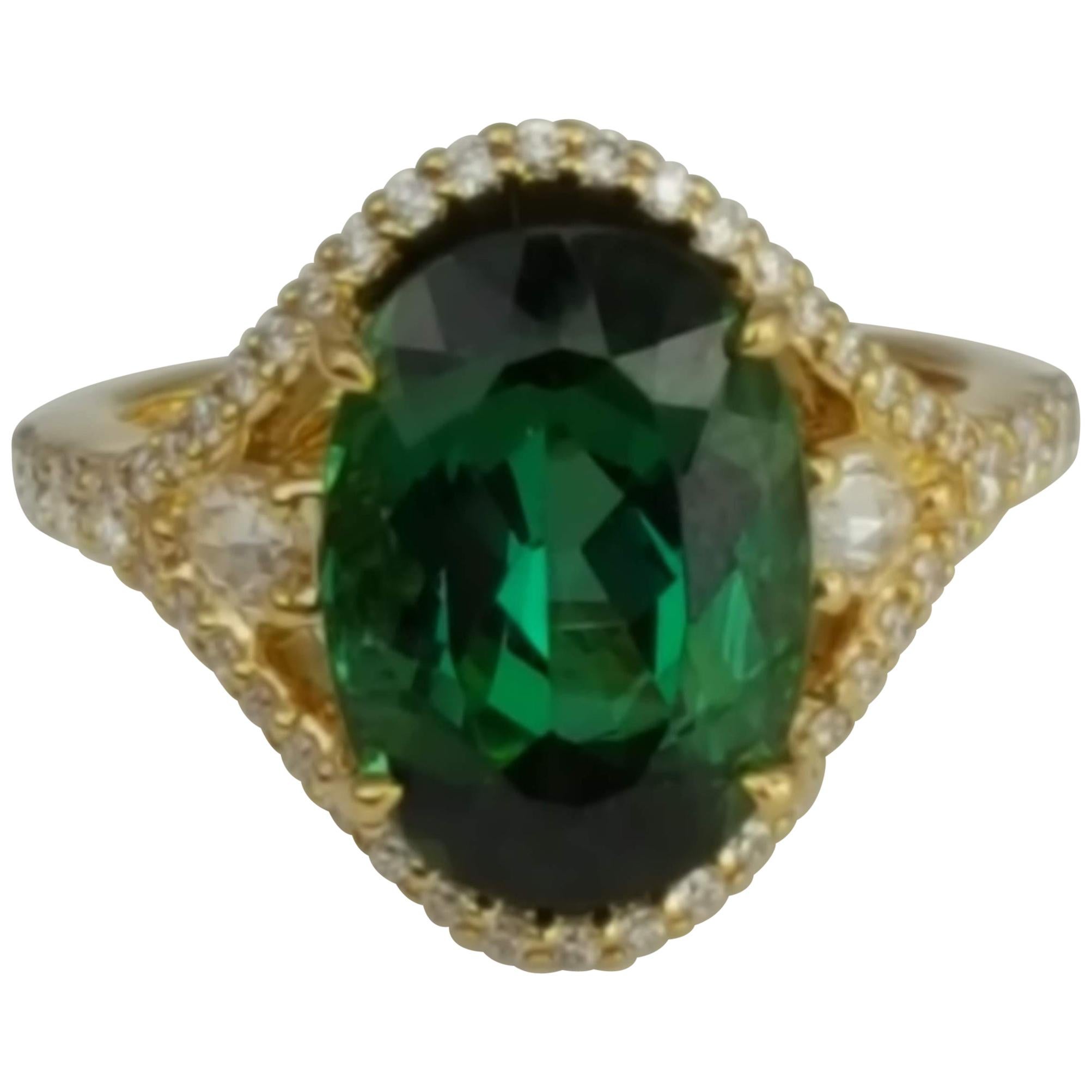 (DiamondTown) With a 6.41 carat exotic Green Tourmaline center, embellished by 0.63 carats round and pear shape diamonds, this ring has a simple elegance suited for every occasion.

Center: 6.41 Carat Green Tourmaline.
Two pear shape diamonds total