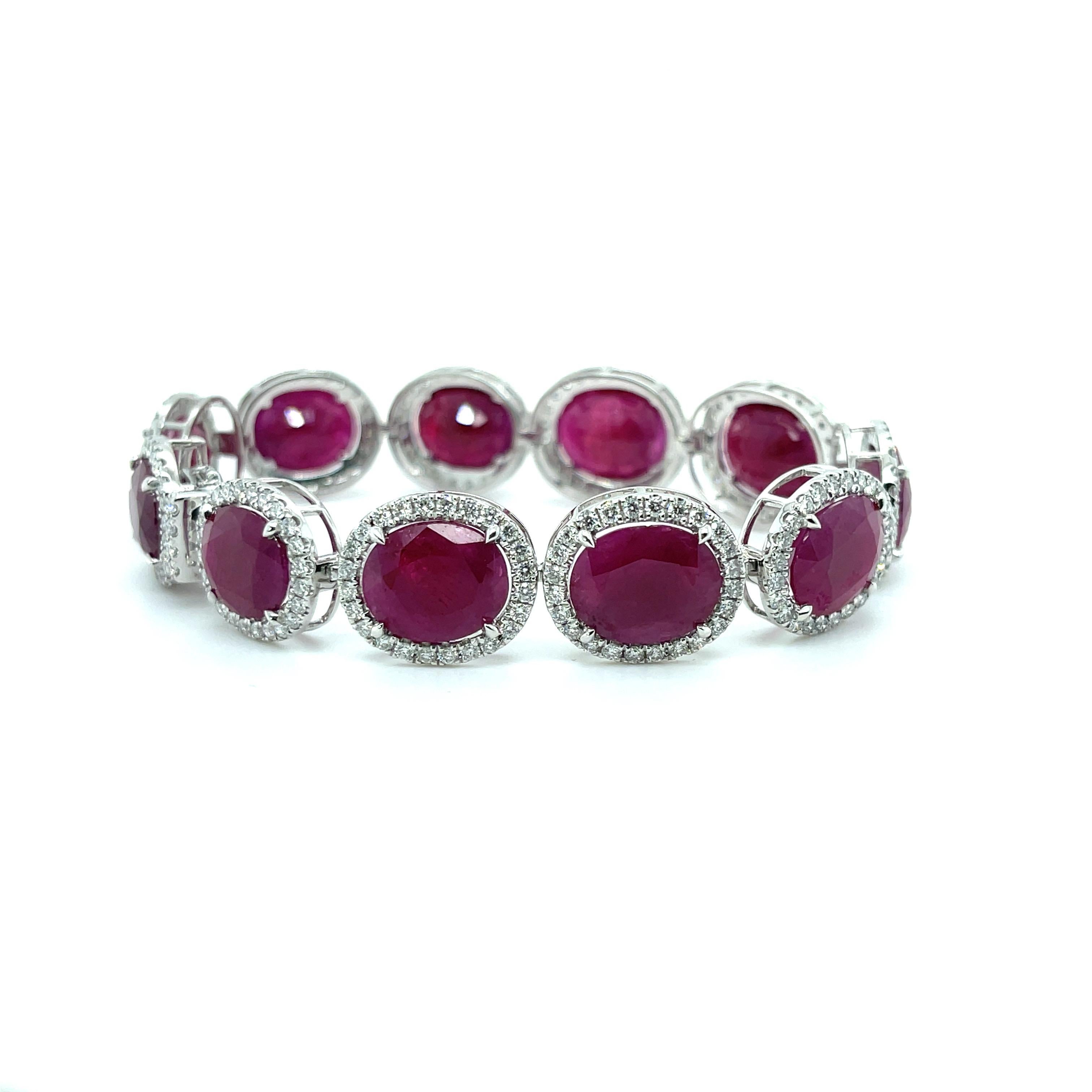 Natural Rubies and Diamonds, crafted in Platinum, complimented by a stunning polished finish design.

Item: One stamped Platinum (PT 950) Ruby and diamond bracelet featuring;


Eleven Rubies, 64.14ct ctw, 12.96mm x 10.94mm x 5.5  mm (average)