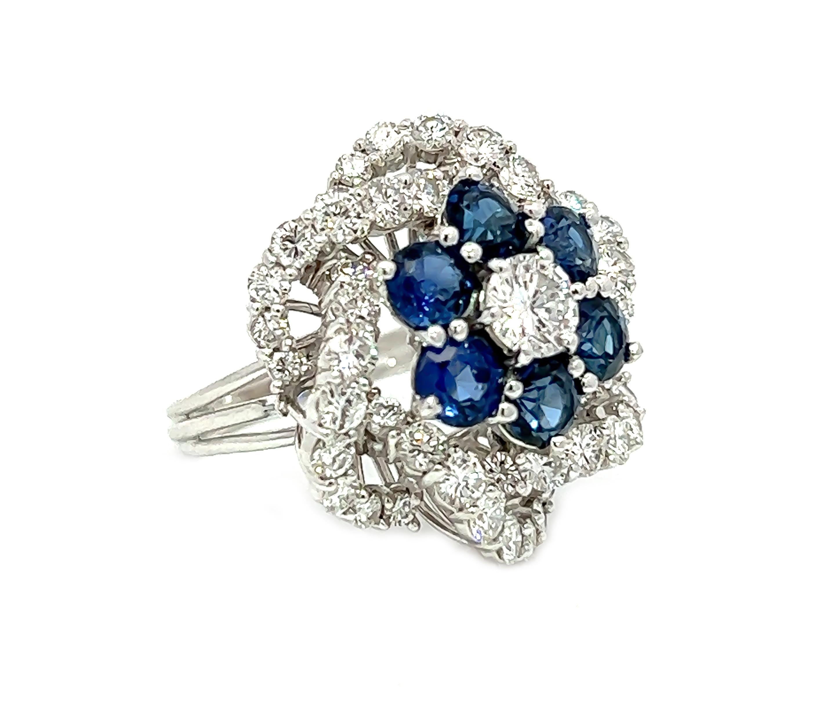 This exquisite ring boasts a truly unique setting, with a stunning 0.50 carat round brilliant diamond as the centerpiece of the flower design. It is further adorned with six sapphire stones, totaling an impressive 2.40 carats. Adding to its allure,