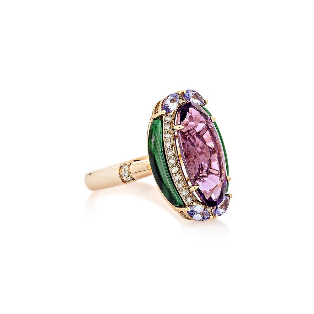 An oval-shaped amethyst stone with a checkerboard cut appears in the ring. On The top and bottom have studded tanzanite in marquise form on both sides, and the malachite stones in fancy cut on the side of the amethyst stone perfectly represent the