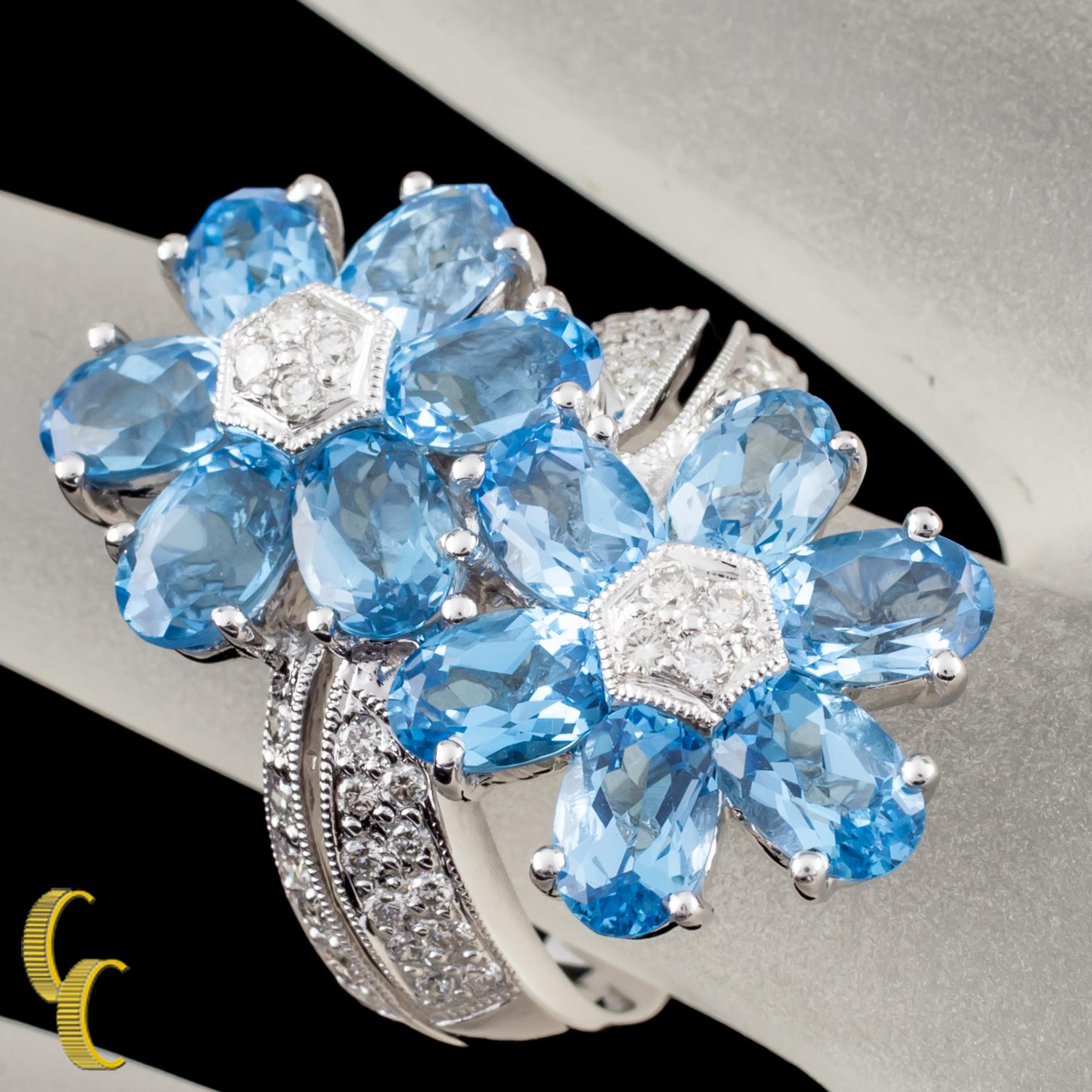 18 karat white gold setting 
Ring size = 5 1/2
Piece is in great condition
Blue Topaz flower petals accented with Diamonds
Total Topaz weight: 6.42 carats
Total Diamond weight: 0.44 carats
Diamond Clarity Grade: VS average
Diamond Color Grade: