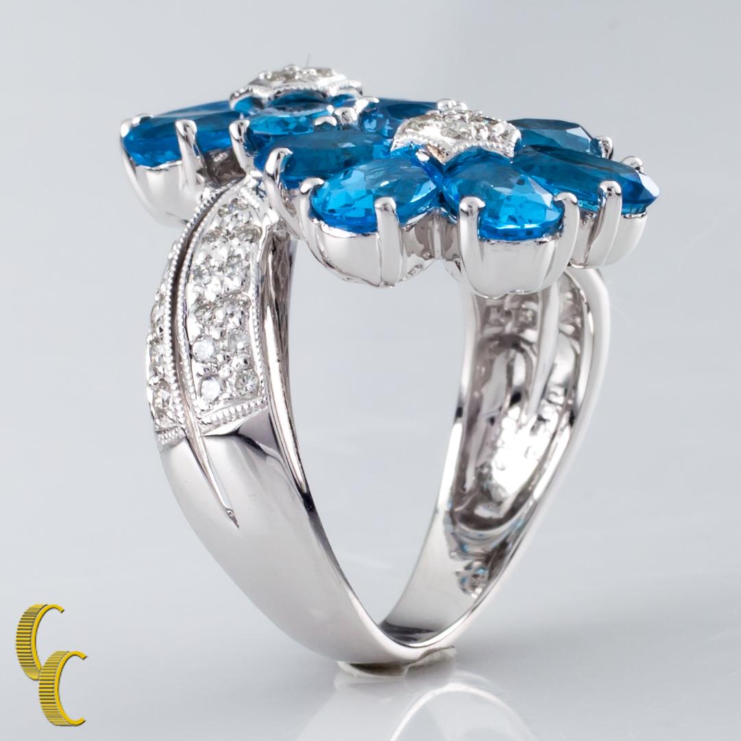 Oval Cut 6.42 Carat Blue Topaz Flower Ring with Diamond Accents in White Gold For Sale