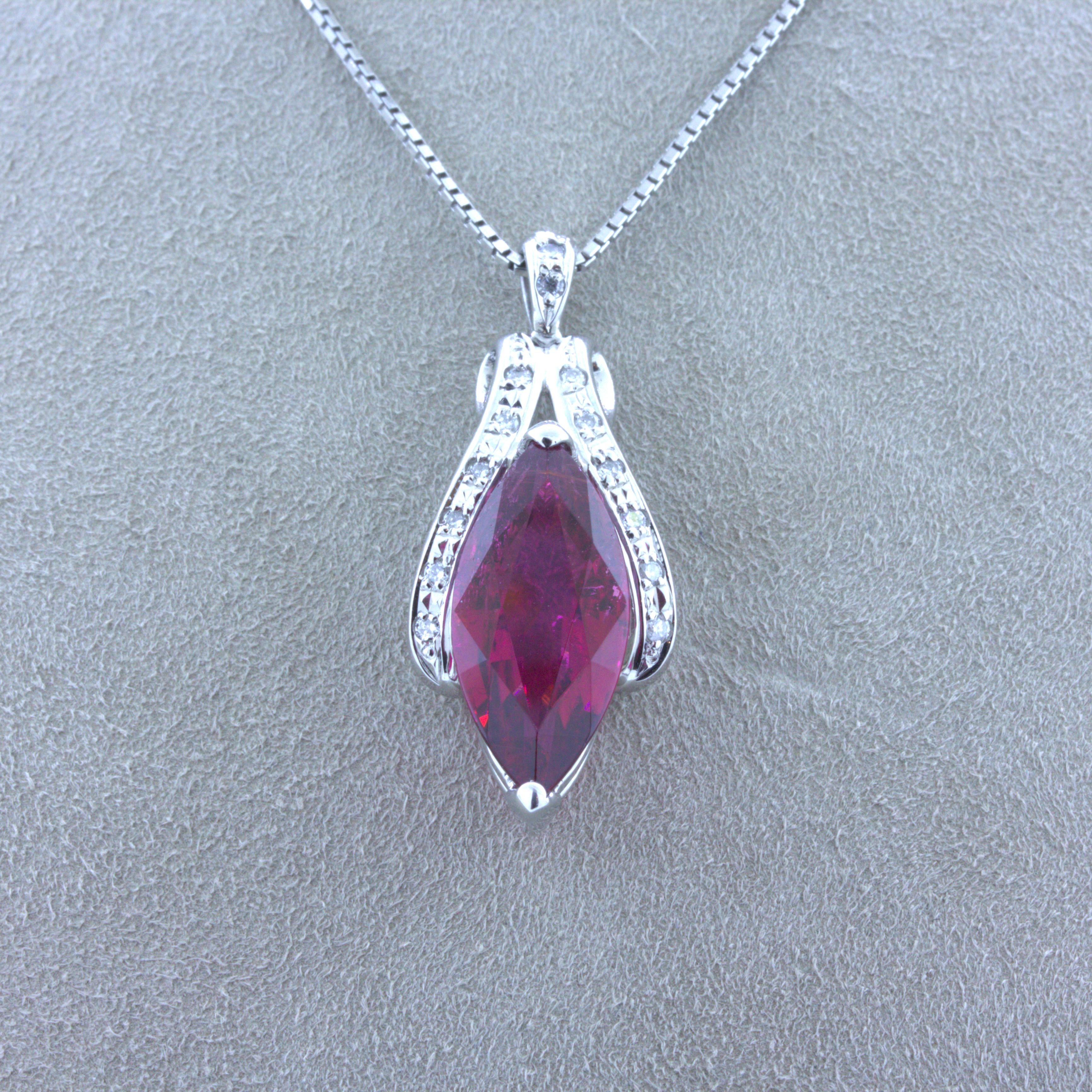 A chic and elegant pendant made in platinum featuring a very fine 6.42 carat rubellite tourmaline. It has a sleek marquise-shape along with extra fine vivid red color with a hint of purple which glows intensely in the light. It is complemented by