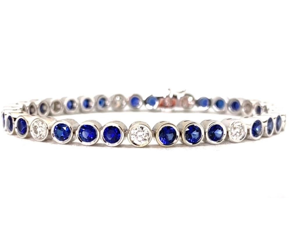 This stylish and elegant tennis bracelet features over 6 carats of blue sapphires and over 2 carats of white diamonds, with each gem showcased in its own 18k white gold bezel. The sapphires have extraordinarily fine color and are beautifully