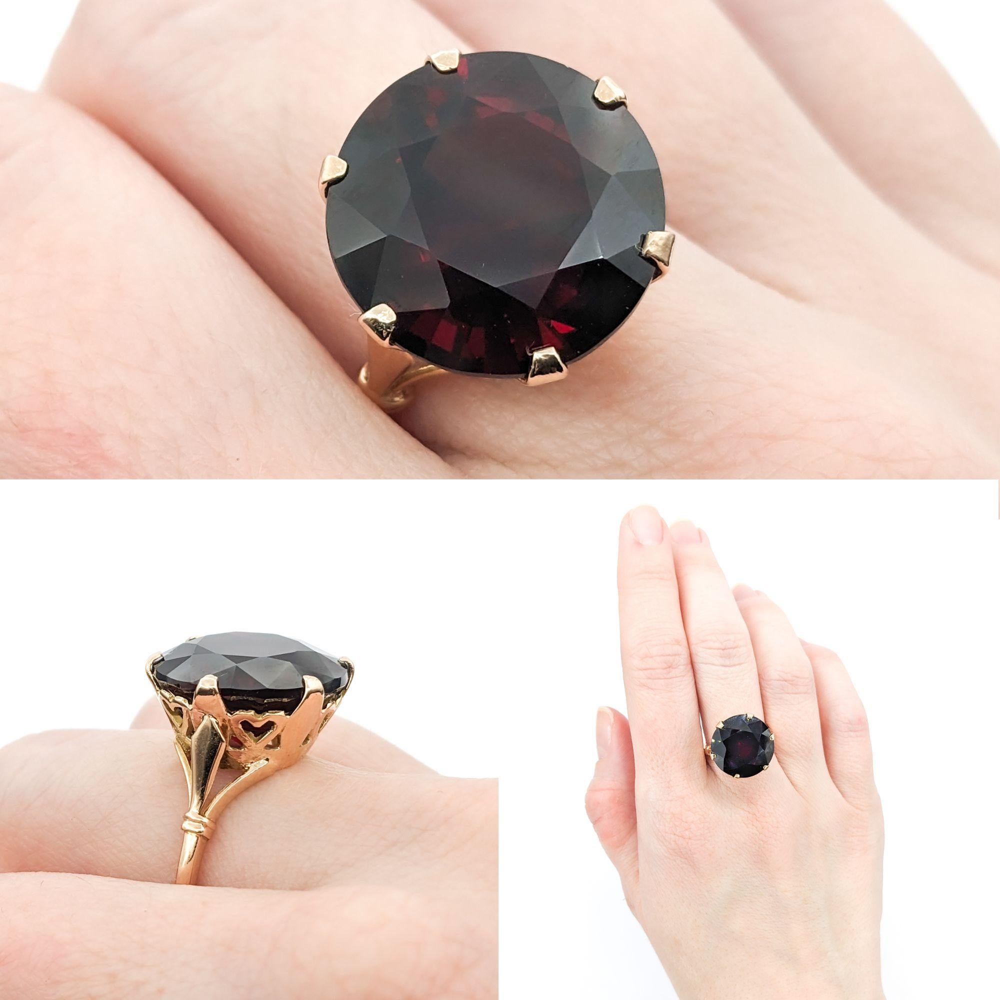 16.42ct Natural Pyrope Garnet Ring In Yellow Gold

Introducing this exquisite natural Garnet Statement Ring, masterfully crafted in 14k Yellow Gold. At its heart lies a magnificent 16.42ct natural round Pyrope Garnet with a captivating wine red