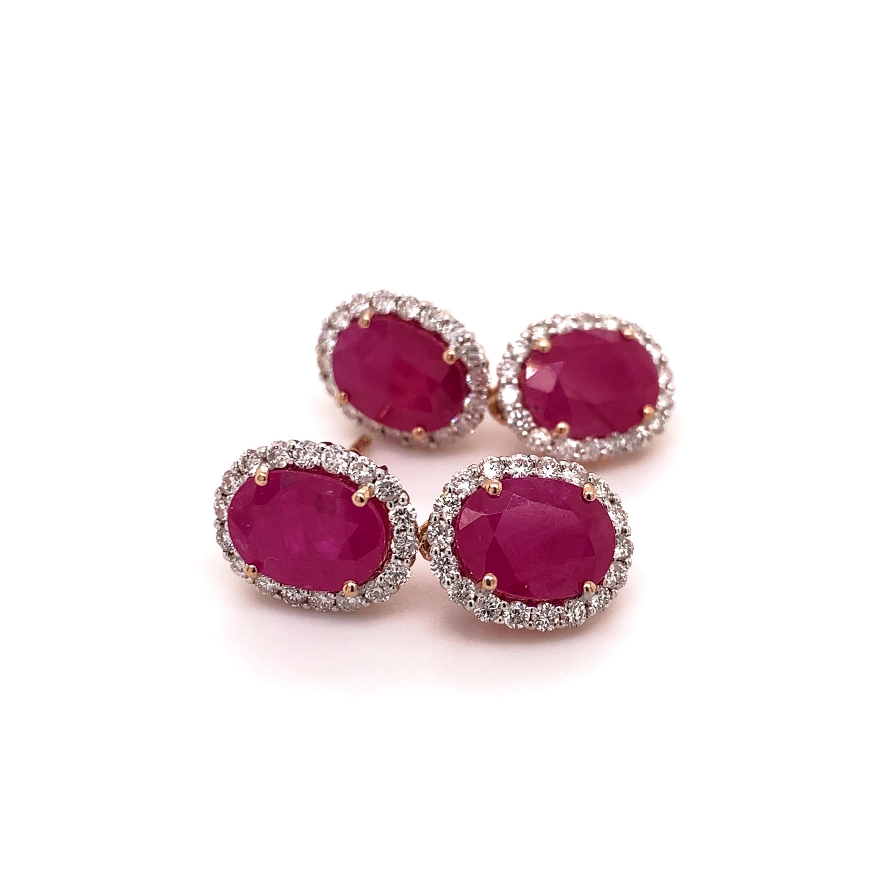 Stunning ruby diamond dangling earrings. High brilliance, lively rich pinkish red oval faceted natural 6.43 carats rubies encased open basket, accented with round brilliant cut halo design. Handcrafted design set in 14 karats rose gold with tapered