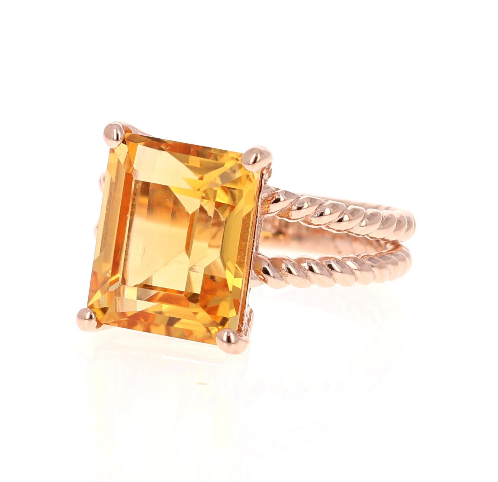 This beautiful, designer inspired ring has a bright and vivid Emerald Cut Citrine Quartz in the center that weighs 6.45 carats. 
The setting is beautifully crafted in 14K Rose Gold and weighs approximately 5.3 grams.
The ring is a size 7 and can be