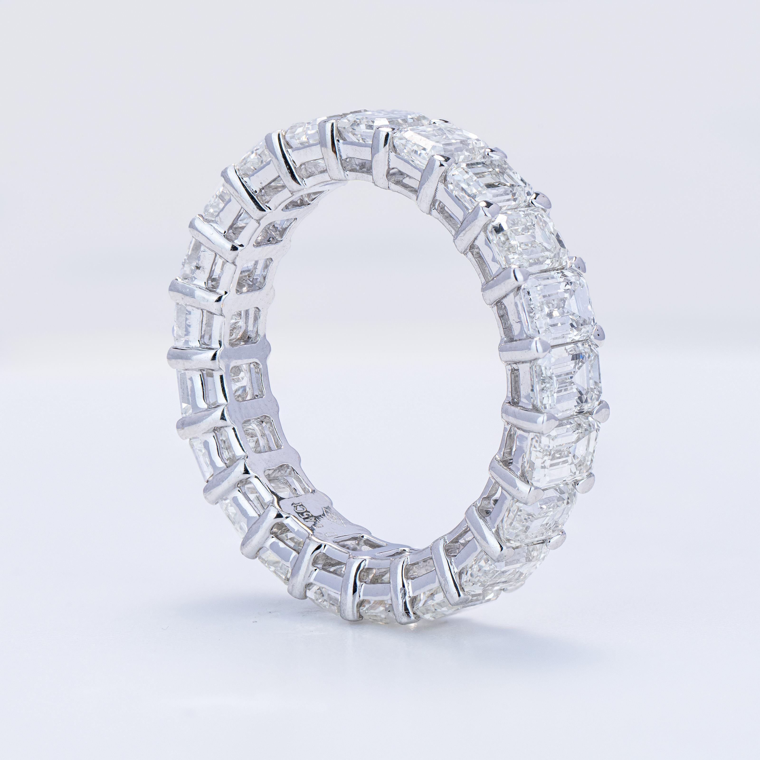 Crafted from 18kt white gold, this eternity band ring exudes timeless elegance and sophistication. The ring has 21 emerald-cut diamonds totaling 6.45ct with color of F-G and clarity VS-1. The total average stone is 1/3 of a carat. The finger size is