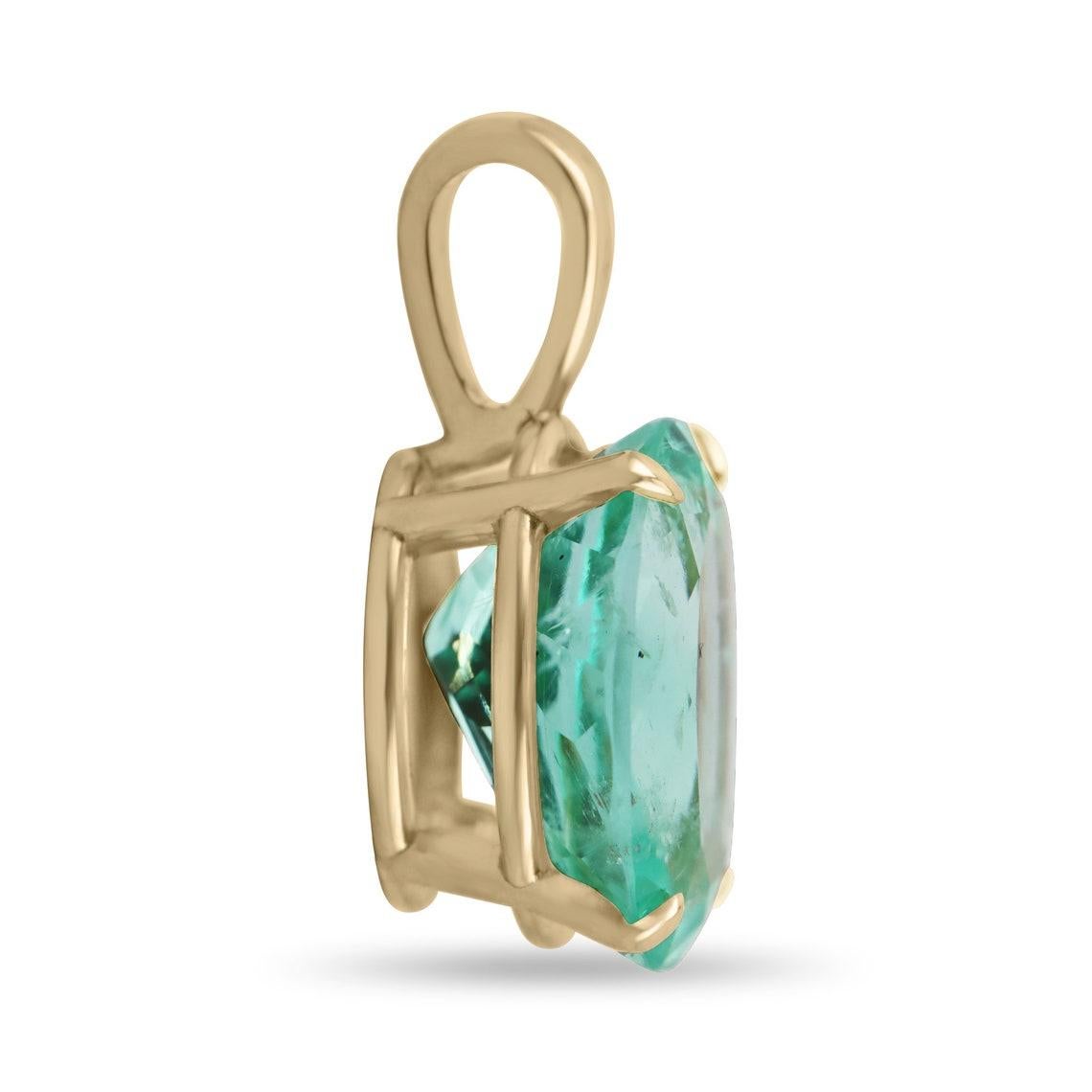 Featured here is a stunning oval Colombian emerald pendant in fine 18k yellow gold. Displayed in the center is a medium-green emerald accented by a simple four-prong gold mount, allowing for the emerald to be shown in full view. This emerald is