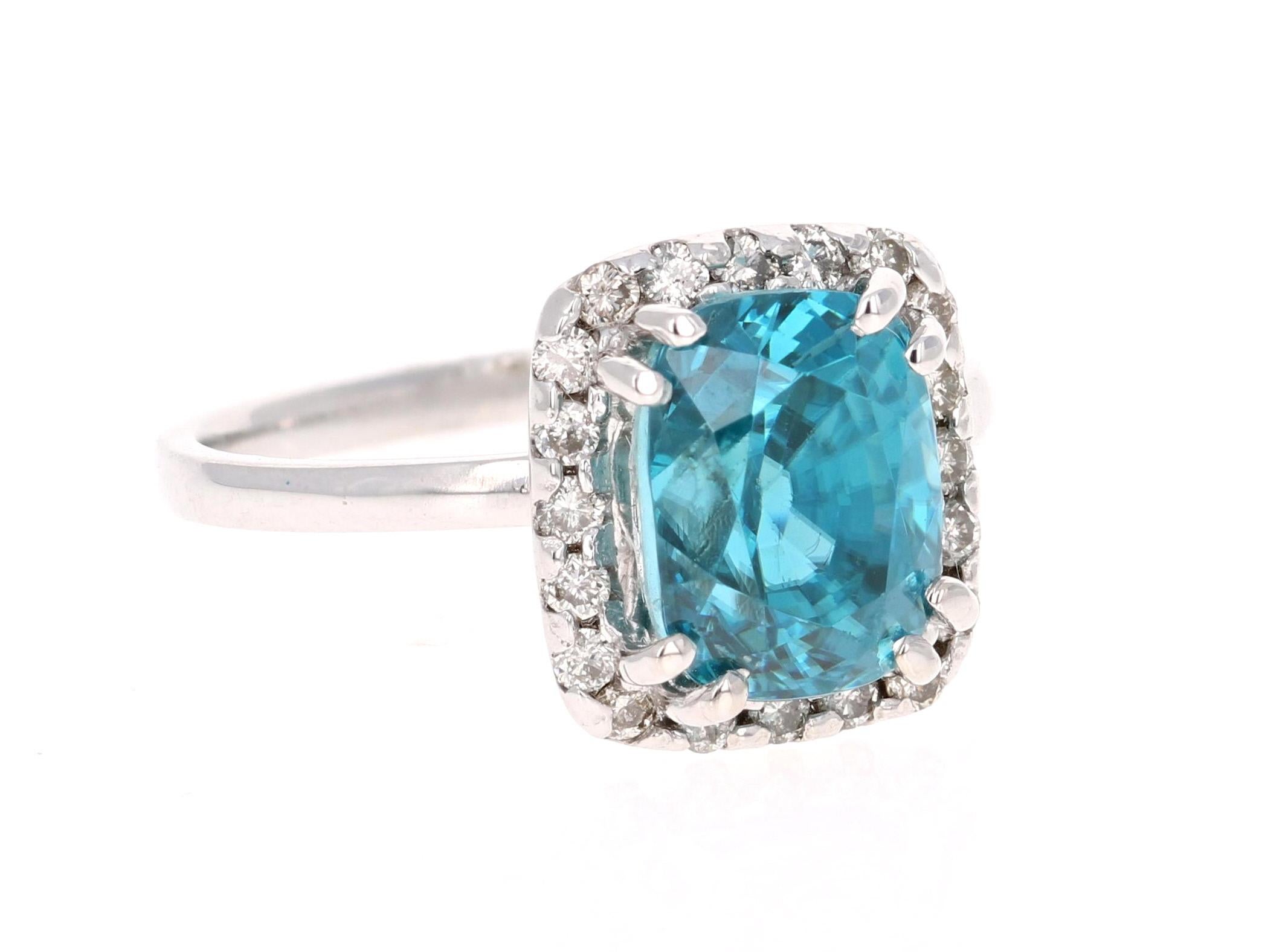 A Dazzling Blue Zircon and Diamond Ring! Blue Zircon is a natural stone mined in different parts of the world, mainly Sri Lanka, Myanmar, and Australia. 

This Oval Cut Blue Zircon is 6.13 Carats and is surrounded by a double halo of 20 Round Cut