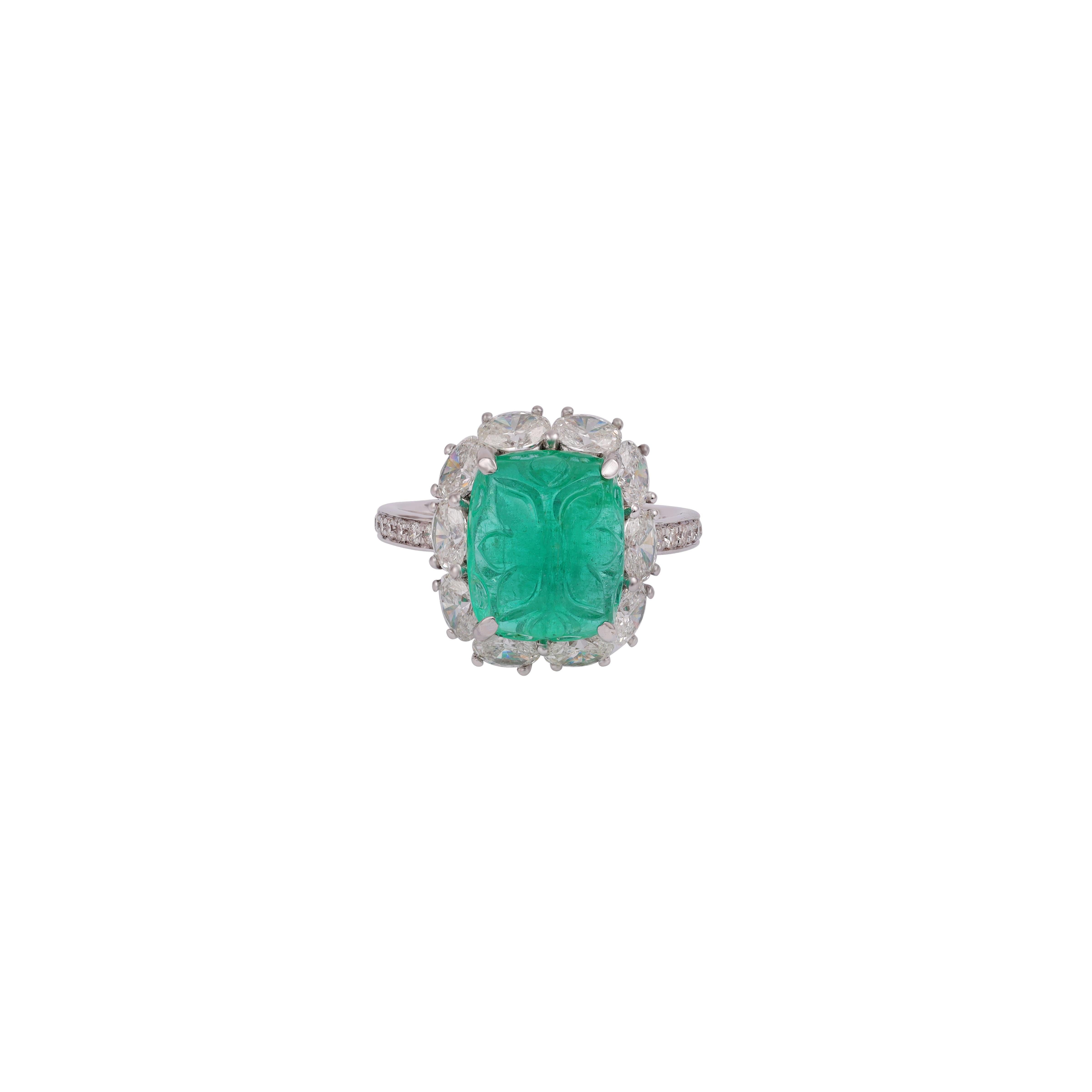 This is an elegant emerald & diamond ring studded in 18k white gold with 1 piece of Carved Zambian emerald weight 6.46 carat which is surrounded by 10 pieces of round shaped diamonds weight 1.86 carat, this entire ring studded in 18k white gold