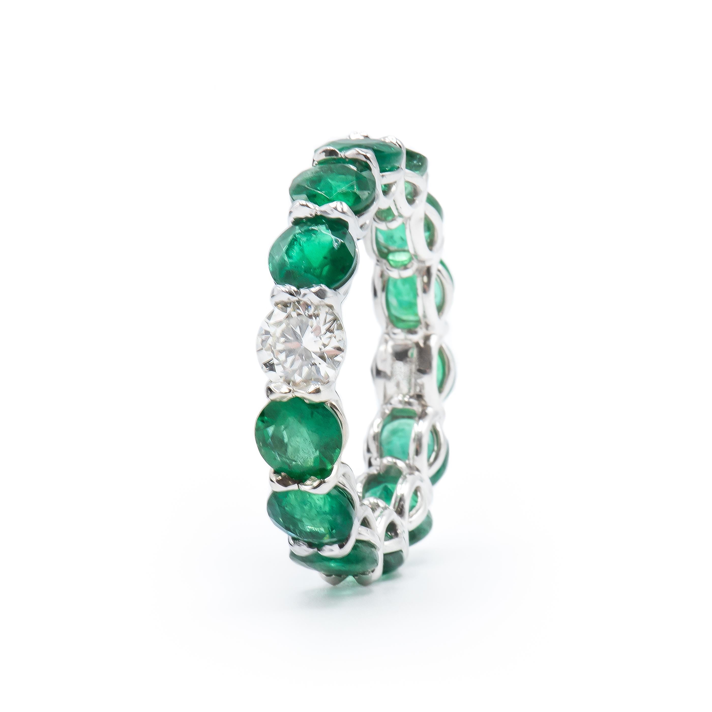 This beautiful Ring features 13 Green Emeralds with 1 Round Brilliant Diamond center totaling 6.46 Carats.

13 Emeralds weigh 5.95 Carats.
1 Diamond weighs 0.51 Carats.
Set in Platinum.
Finger Size 6