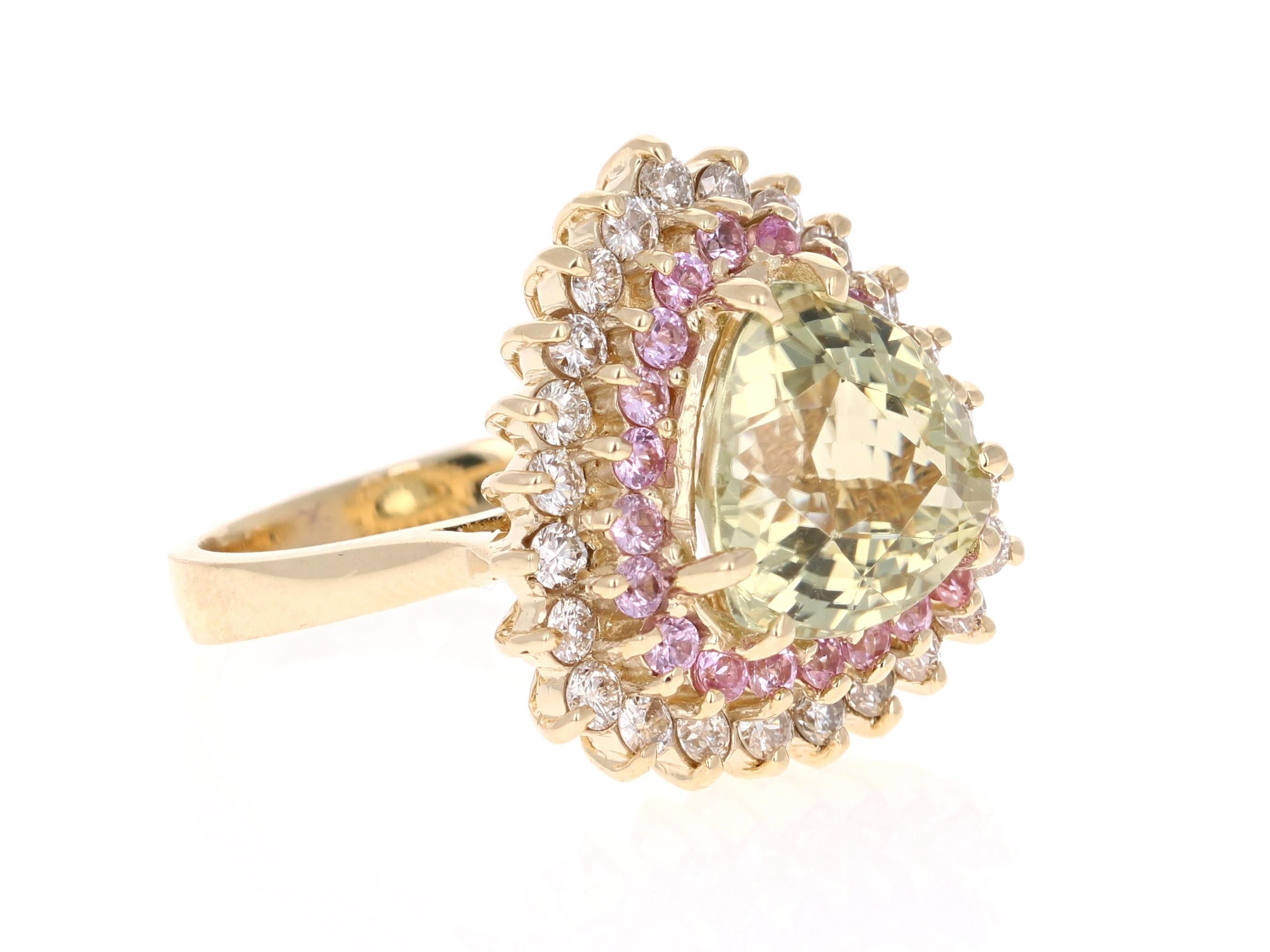 A uniquely designed piece that is sure to elevate your accessory wardrobe!  

This beauty has a Trillion Cut Light Green Tourmaline set in the center of the ring that weighs 5.01 carats.  It is surrounded by 21 Round Cut Pink Sapphires that weigh