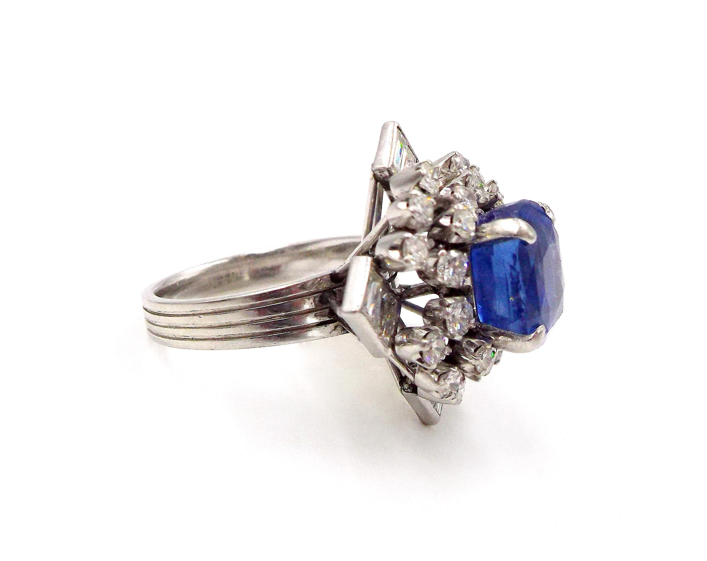 Centering one cushion-shaped sapphire 6.46 cts., within a square-shaped mount of 24 round and 12 baguette diamonds 2.20 cts., 8.6 dwts. Size 7. 
With AGL report no. 1092785 stating that the sapphire is of Ceylon (Sri Lanka) origin, with no