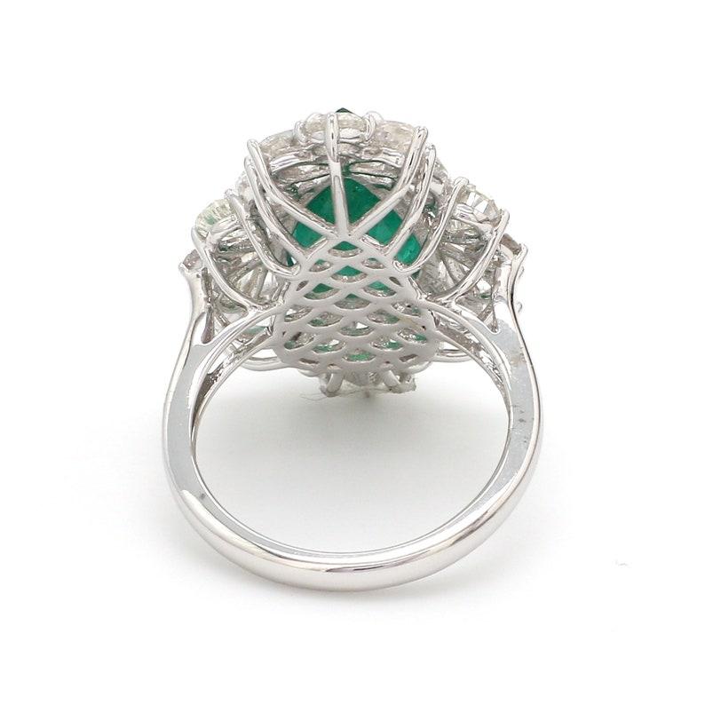 This ring has been meticulously crafted from 14-karat gold.  It is hand set with 6.47 carats emerald & 3.75 carats of sparkling diamonds. 

The ring is a size 7 and may be resized to larger or smaller upon request. 
FOLLOW  MEGHNA JEWELS storefront