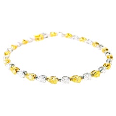 6.47 Carat Natural Yellow And White Diamond Tennis Bracelet, 18K Gold.