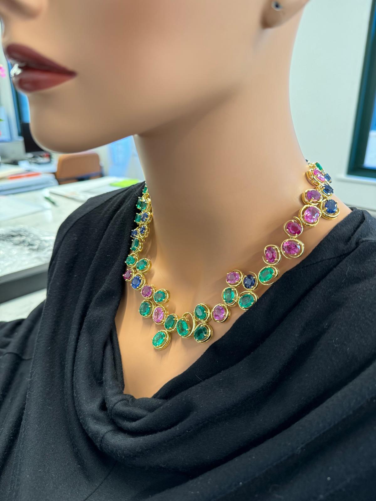 This fashion necklace combines emeralds and sapphires in different colors, with an impressive 64.83 Ct of emeralds and 85.17 Ct of sapphires, likely in oval shapes. The stones’ vibrant green and blue or pink hues create a striking contrast, enhanced