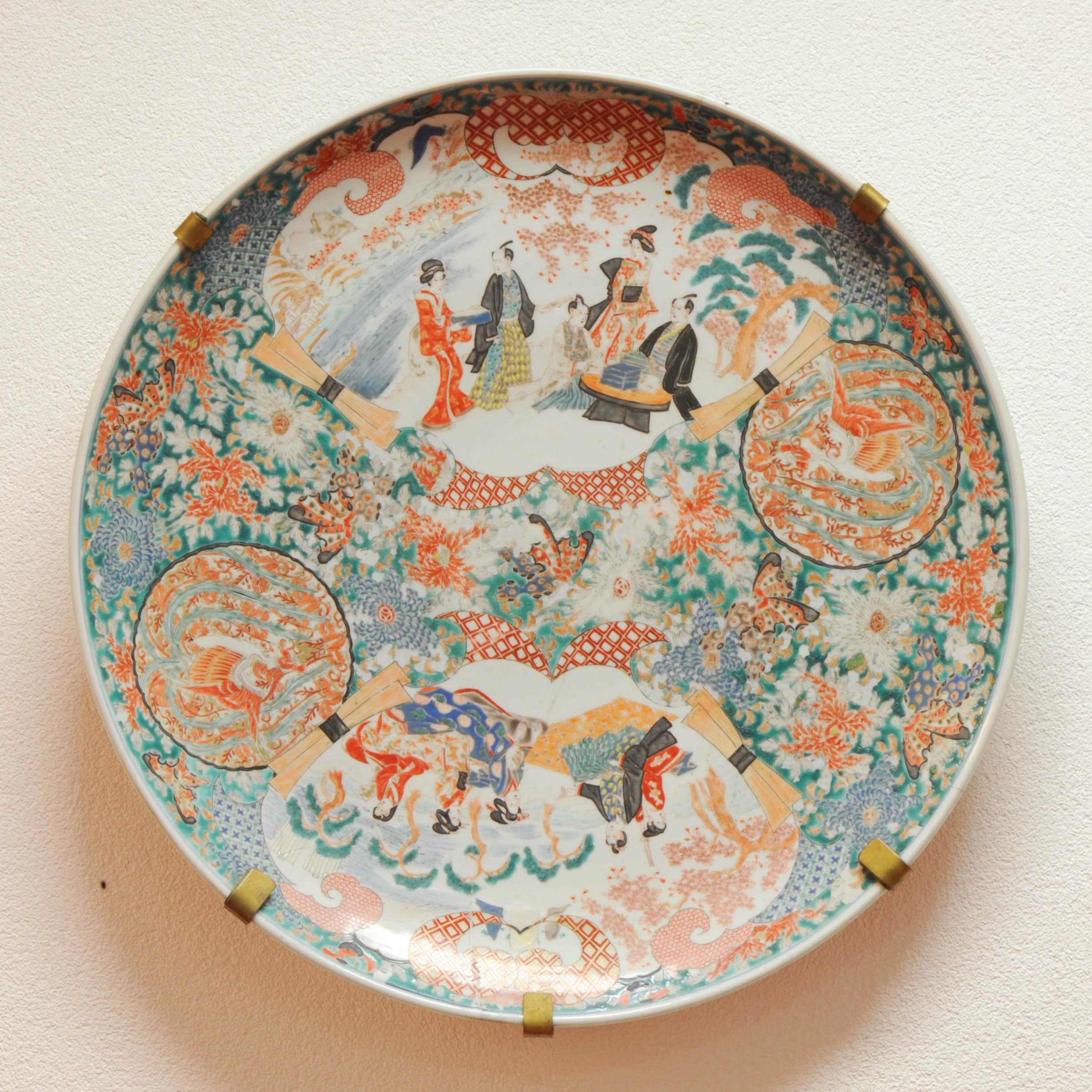 Sharing with you this lovely and rare piece from Japan. It is Majestic in size and also in painting quality. With a richly decorated scene of figures, birds and flowers in a landscape scenes. The backside with flowers and bats.

The piece is