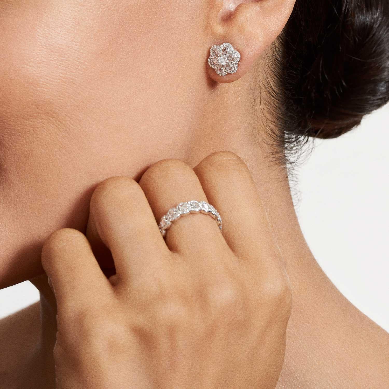 Beautifully feminine, these 1 carat Floral Diamond Stud earrings bring floral inspiration to the everyday. Seven diamonds are accented by smaller brilliant cut diamonds in a micro pave setting to reflect a subtle floral silhouette.

The 0.10 carat