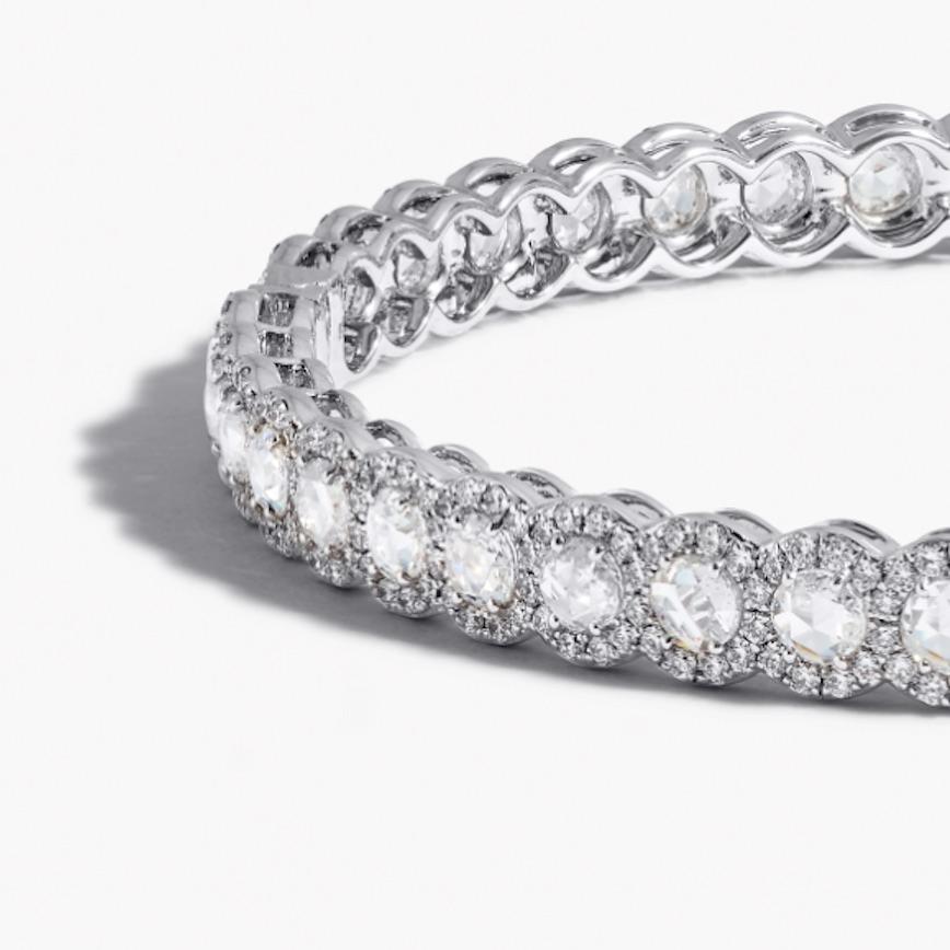 A classic staple to any jewelry collection, 64Facets' Scallop Diamond Bangle provides casual sophistication to any occasion. Each hand cut rose cut diamond is 0.10 carat and is complemented by smaller round brilliant cut diamonds in a micro pave