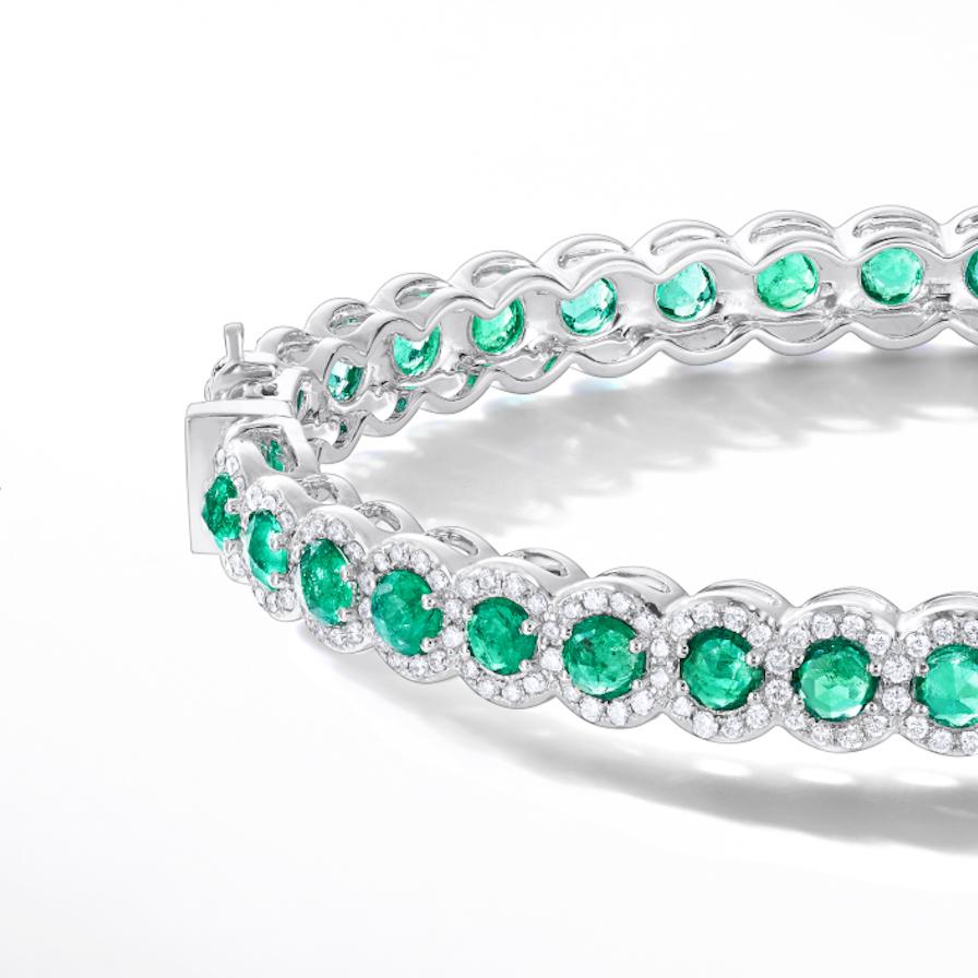 This beautiful bangle features 6.25 carats of rose-cut emeralds flawlessly paired with 1.75 carats of exquisitely crafted smaller brilliant cut diamonds in a micro-pave setting. The brands' signature rose-cut gems glow radiantly from within,