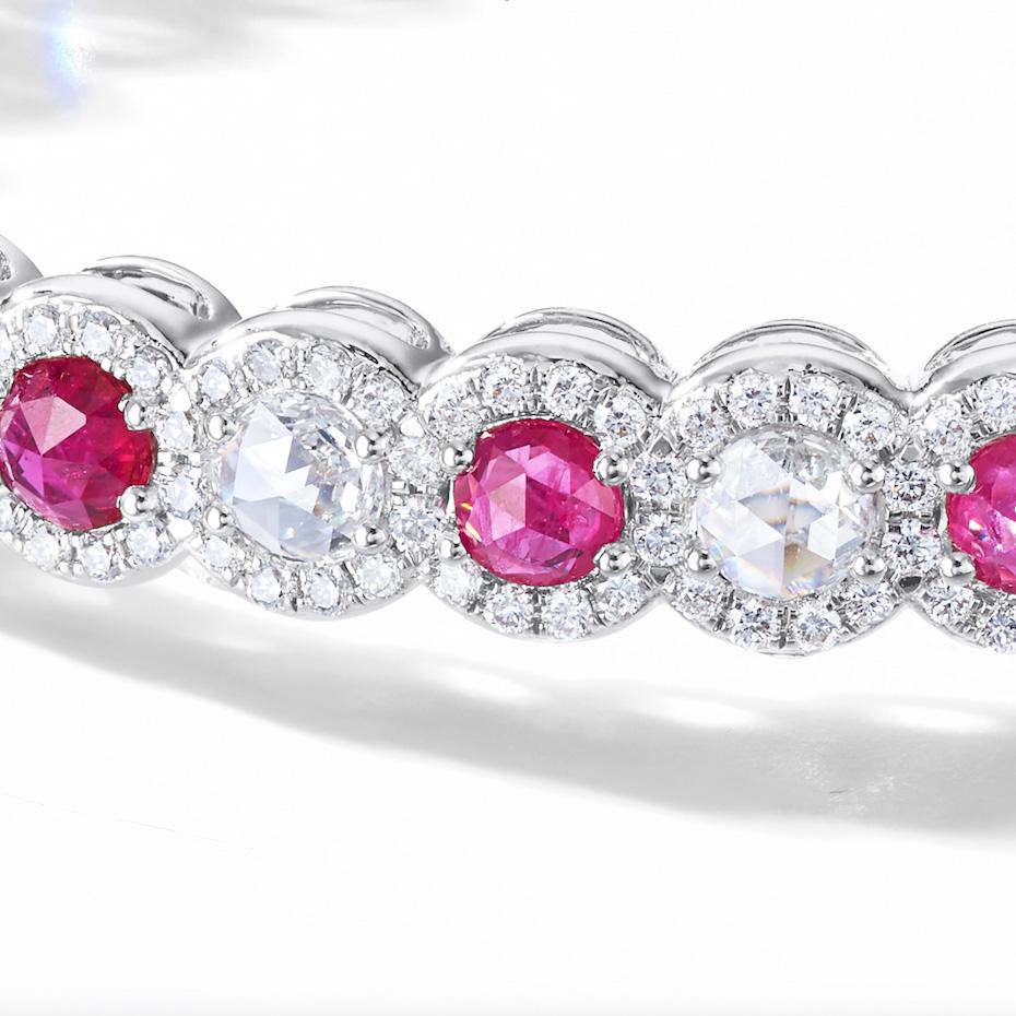 This beautiful bangle features 2.90 carats of rose cut rubies flawlessly paired with 3.25 carats of  rose cut diamonds. Both rubies and diamonds are accented by smaller brilliant cut diamonds in a micro-pave setting. The brands' signature rose-cut