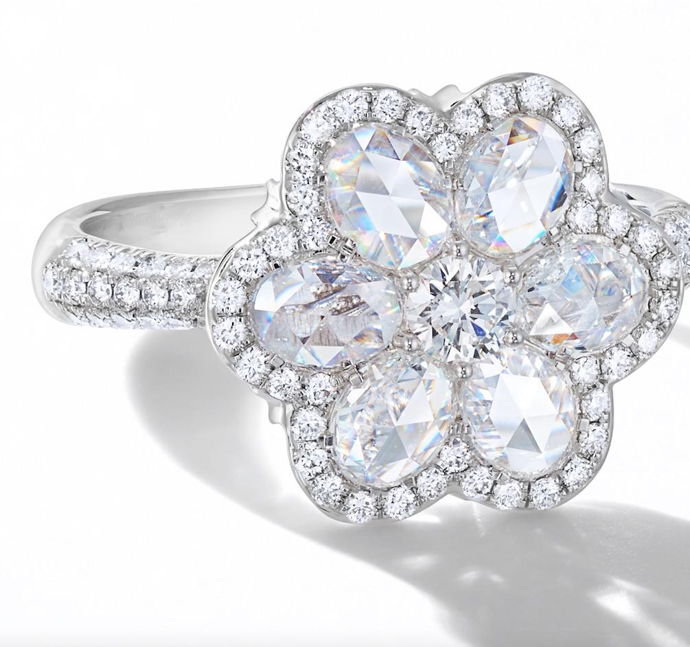 Simple, bright and radiant, this 1.10 carat Floral Diamond Ring is a refreshingly beautiful piece of diamond jewelry that will revive your jewelry collection. Each of the seven centre diamonds is delicately set into floral symmetry and finally