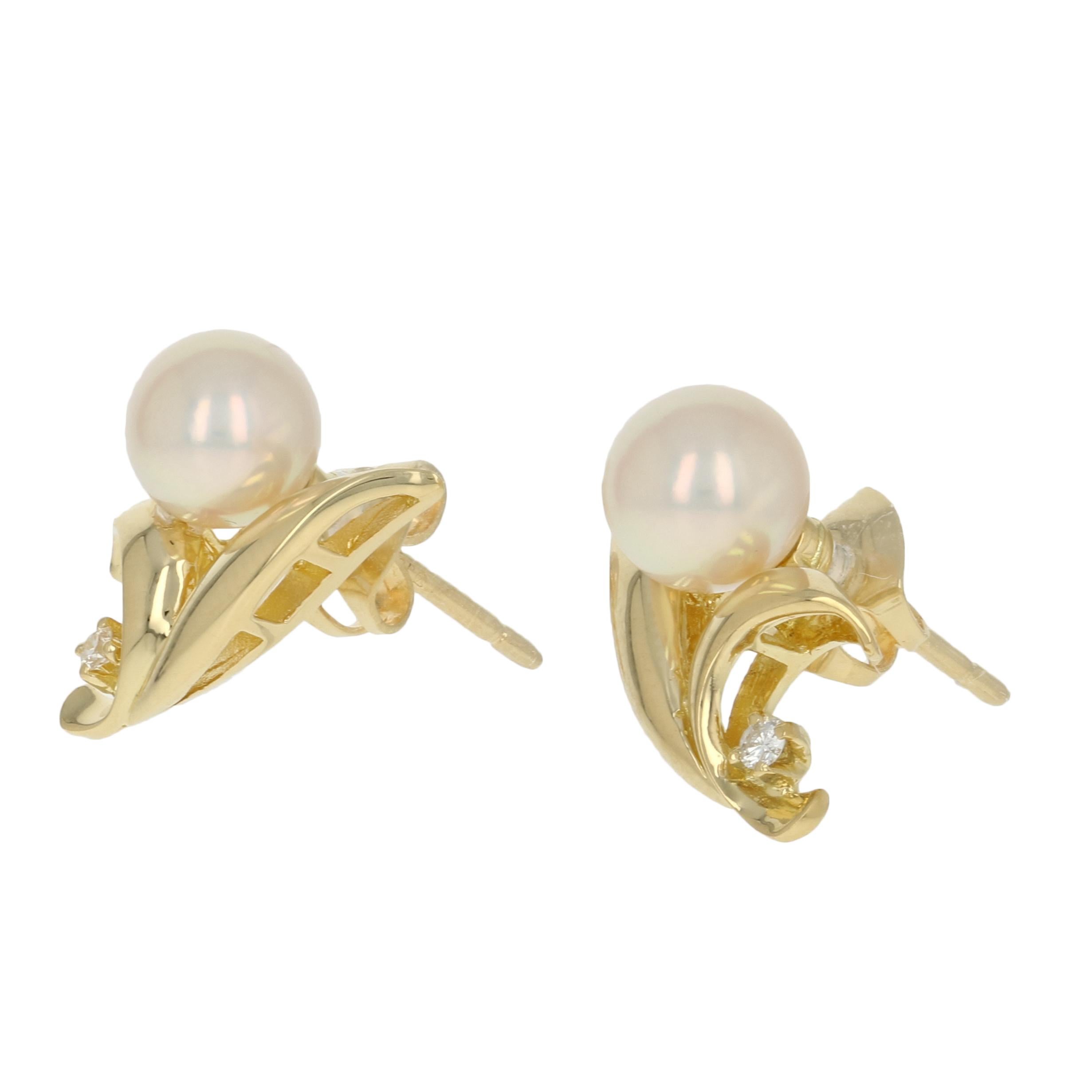 Gracefully elegant and refined, these Mikimoto earrings are destined to become a signature set in your jewelry collection! This pair of 18k yellow gold studs host luminous Akoya pearls sweetly accompanied by radiant white diamond accents.   

Metal