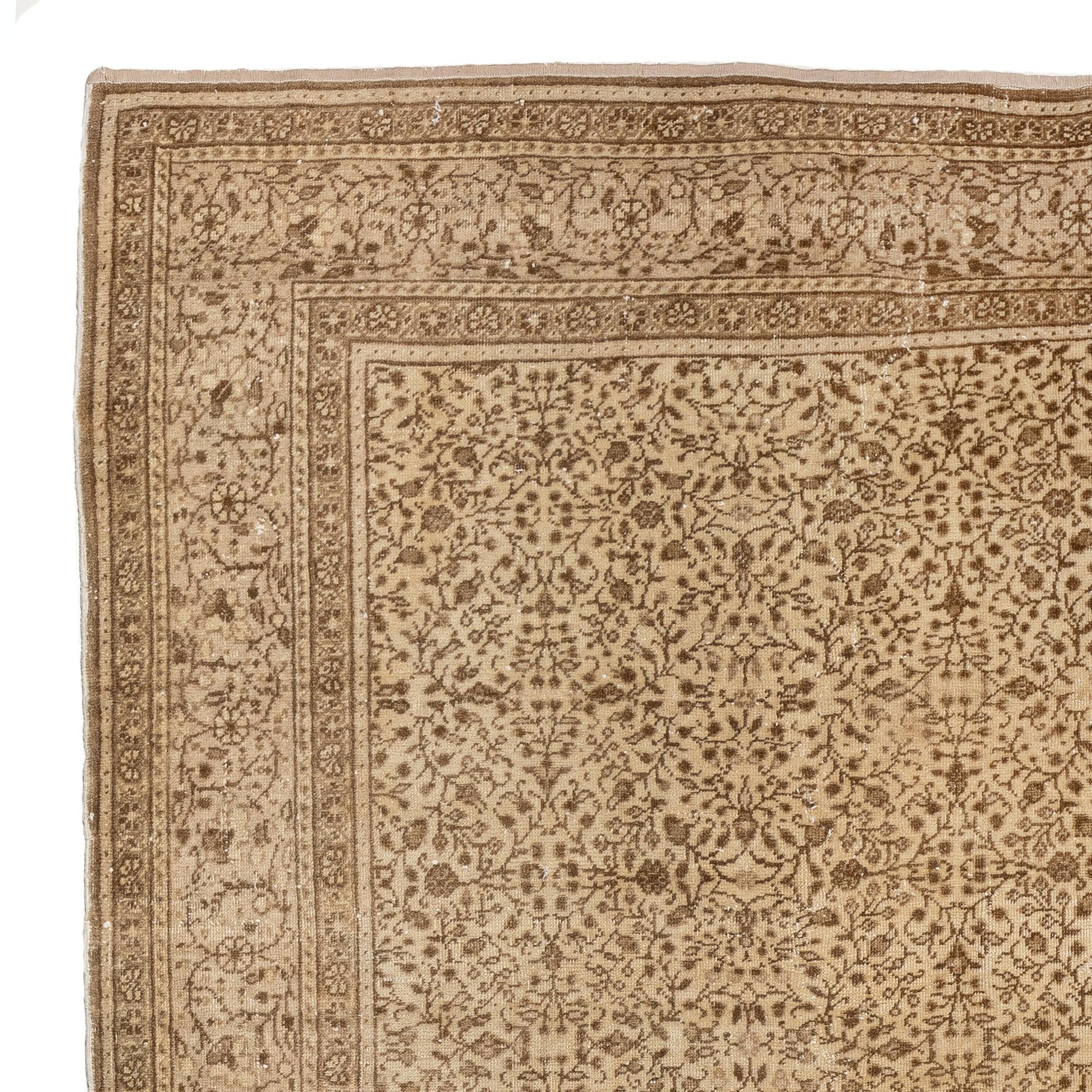 A finely hand-knotted vintage Turkish rug from 1960s featuring an intricately drawn all-over floral design in brown against a golden sand background. 

The rug has even low wool pile on cotton foundation. It is heavy and lays flat on the floor. It