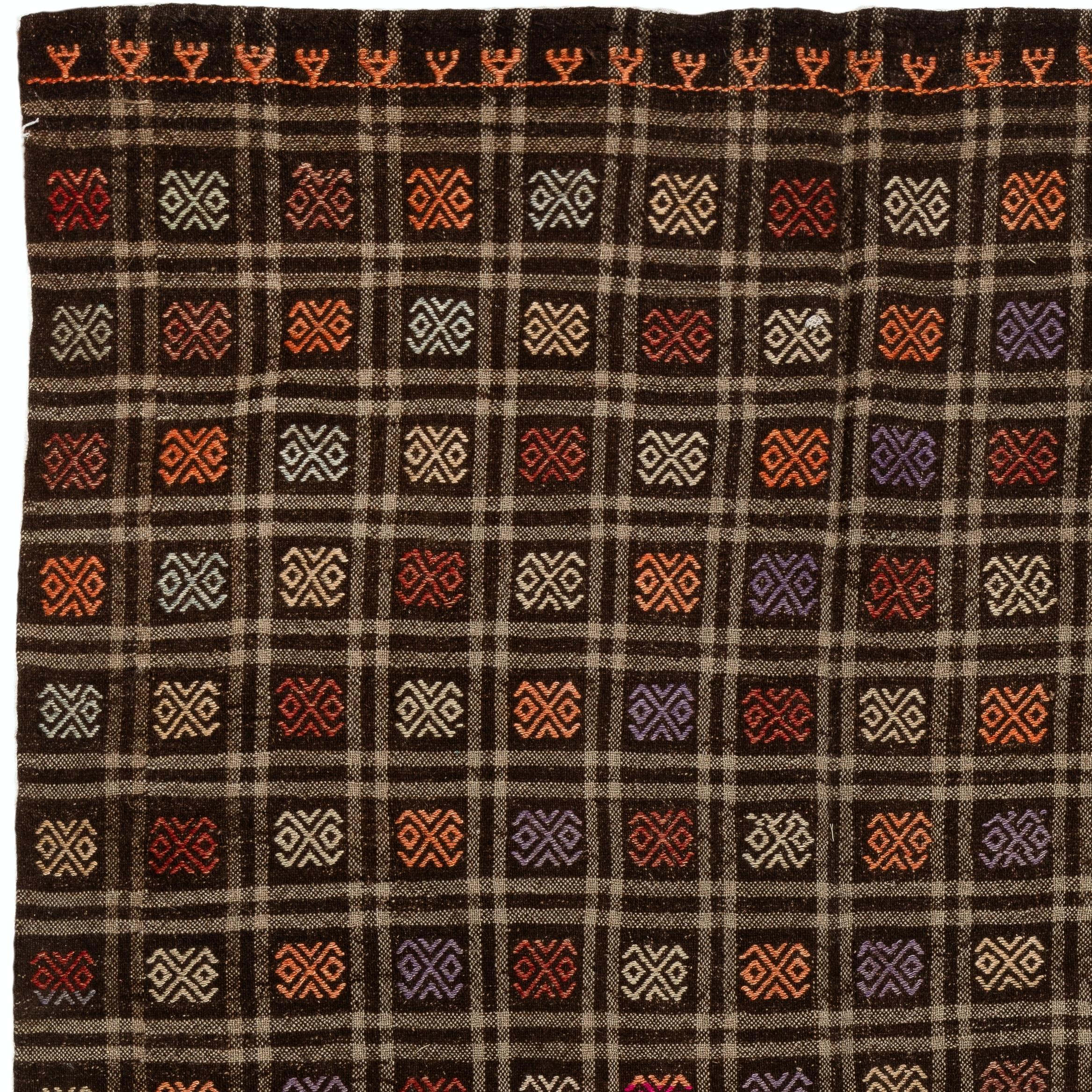 A unique vintage Turkish flat-weave/kilim rug with plenty of visual interest, hand-woven with fine local wool to create a sturdy floor covering. It features all-over double hook motifs, meant as a protection against evil eye, in lavender, red, light