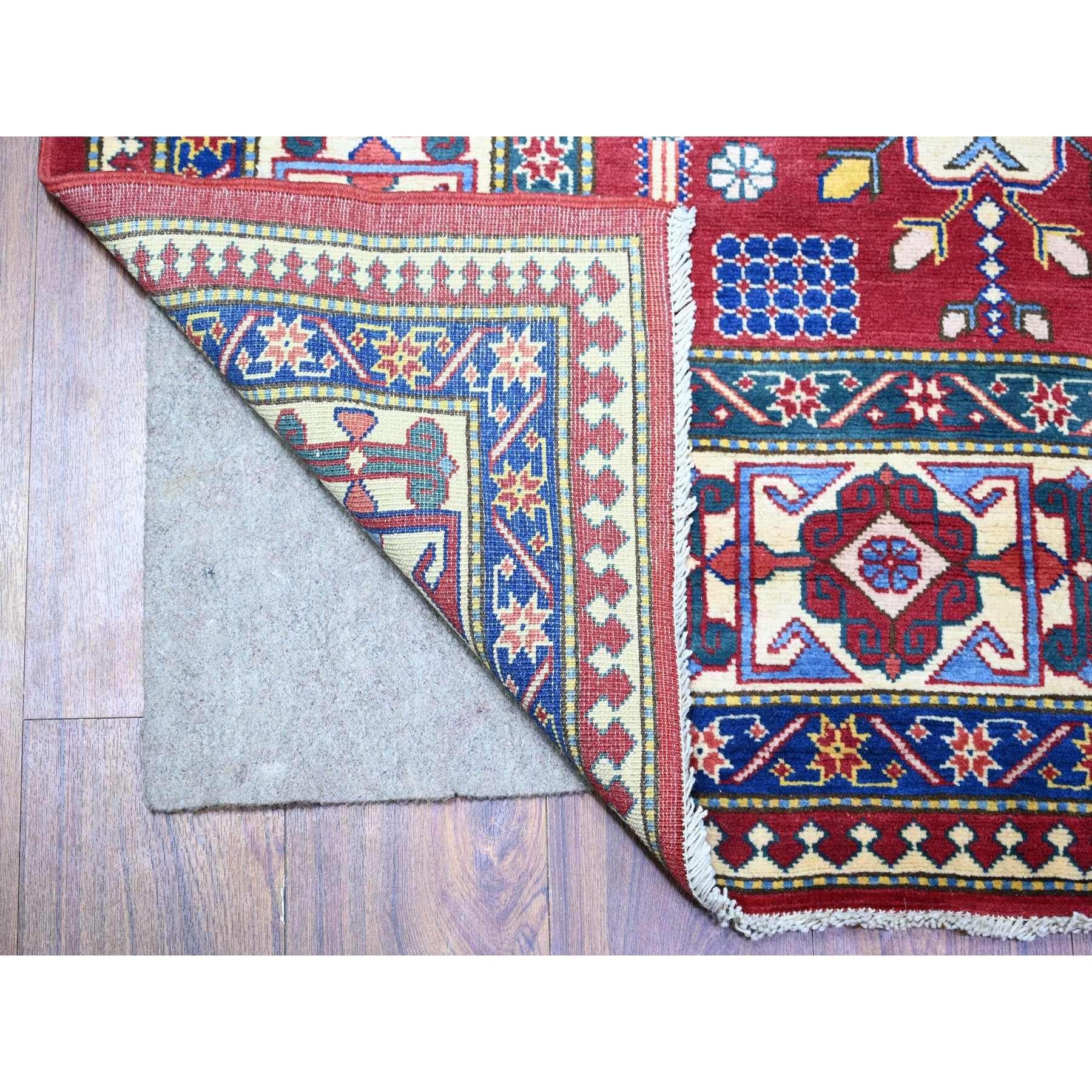 This is a truly genuine one-of-a-kind Hand Knotted Afghan Super Kazak with Shirvan Repetitive Geometrical Rosette Design Pure Wool Oriental Rug. It has been Knotted for months and months in the centuries-old weaving craftsmanship techniques by