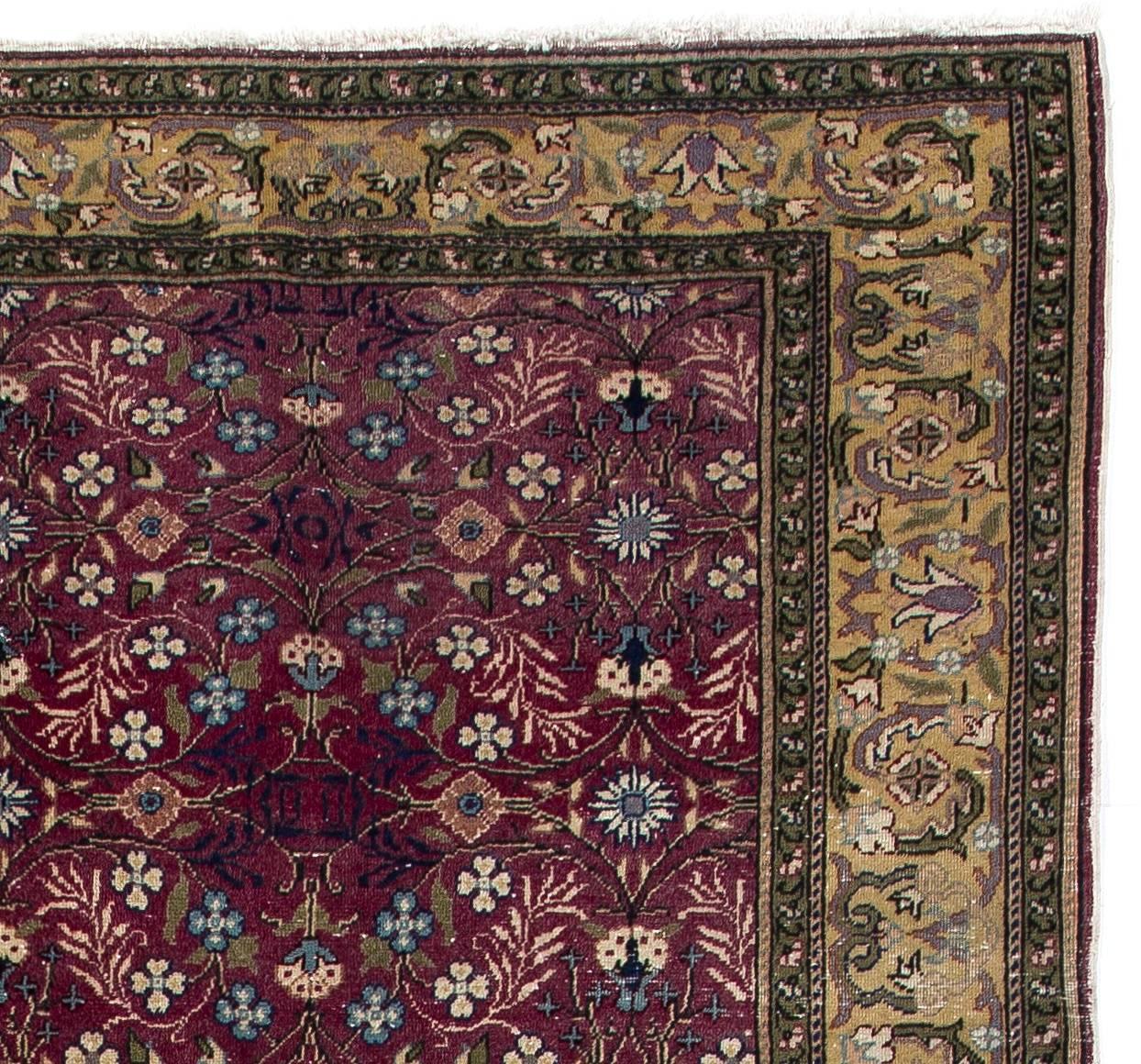A finely hand-knotted vintage Central Anatolian rug with a Classic all-over design of small pattern flowers, leaves and branches on a beautiful plum field framed with a green, purple and soft yellow border.
The high quality wool pile on tight