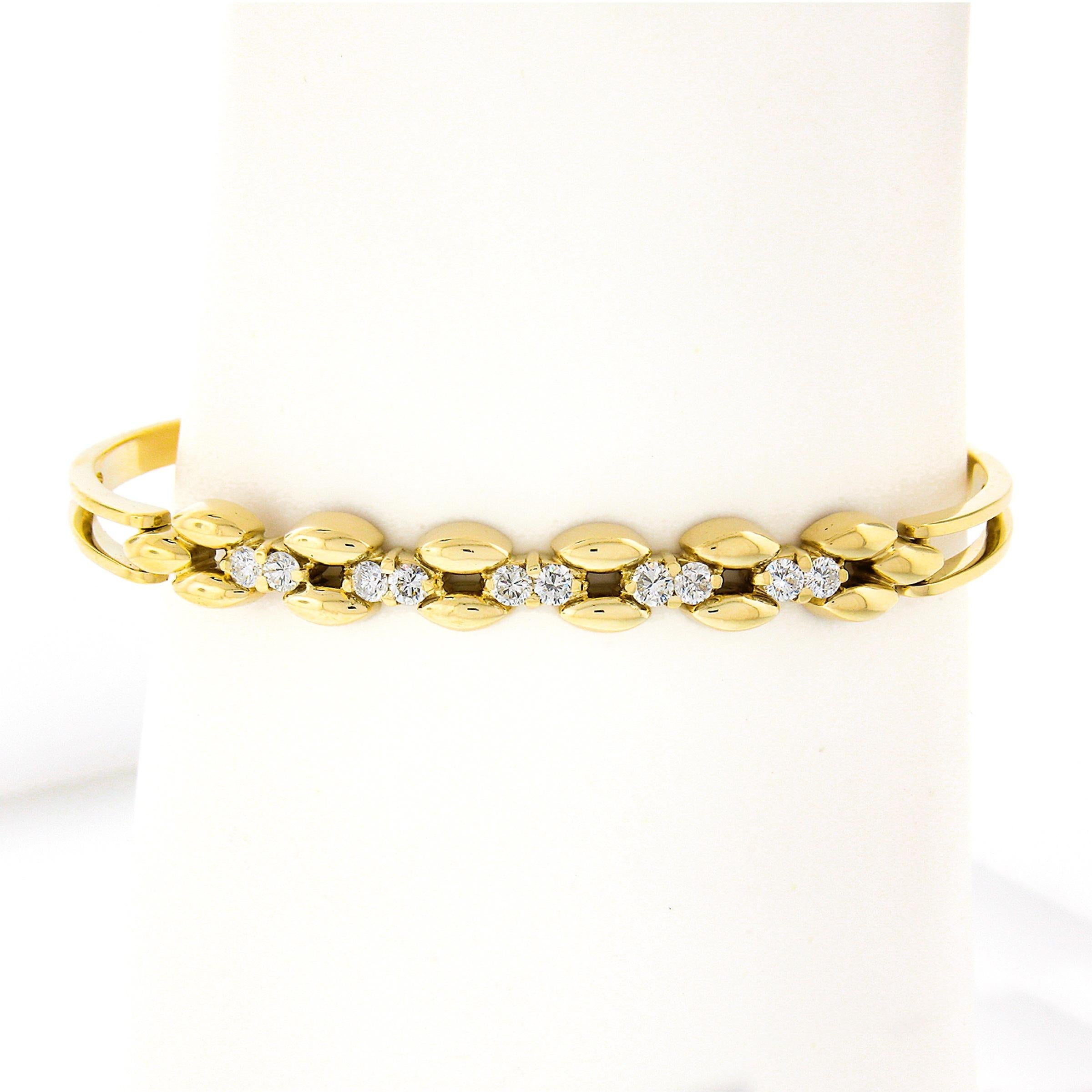 Here we have a gorgeous and well made bangle bracelet that is crafted from solid 14k yellow gold. It features approximately 0.60 carats of fine quality diamonds neatly prong set in sets of two across the elegant open design at the top. The round