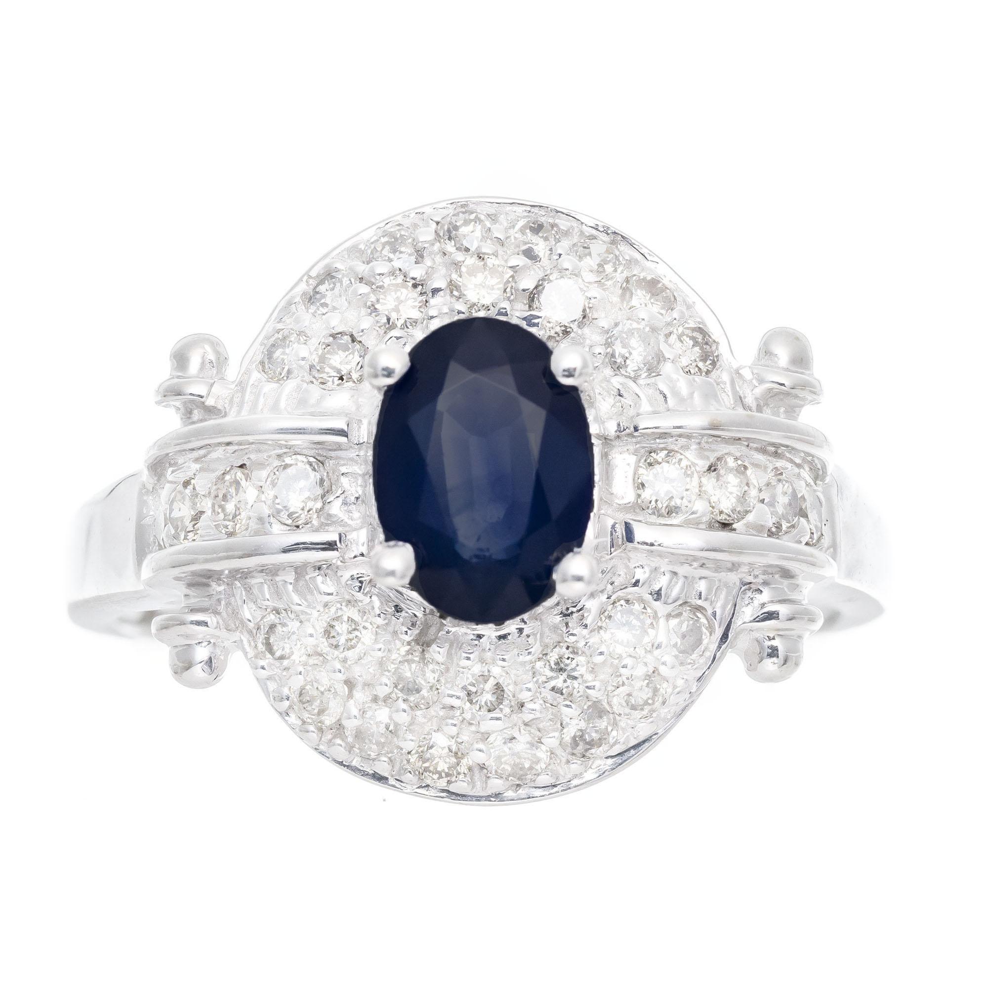 Oval 0.65 carat blue sapphire and brilliant cut diamond cocktail ring. Oval cut center sapphire with a halo of round cut diamonds in a 14k white gold setting. 

1 oval cut blue sapphire, SI approx. .65cts
34 round brilliant cut diamonds, I-J SI