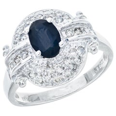 Bague cocktail en or blanc avec saphir bleu de 0,65 carat et halo de diamants