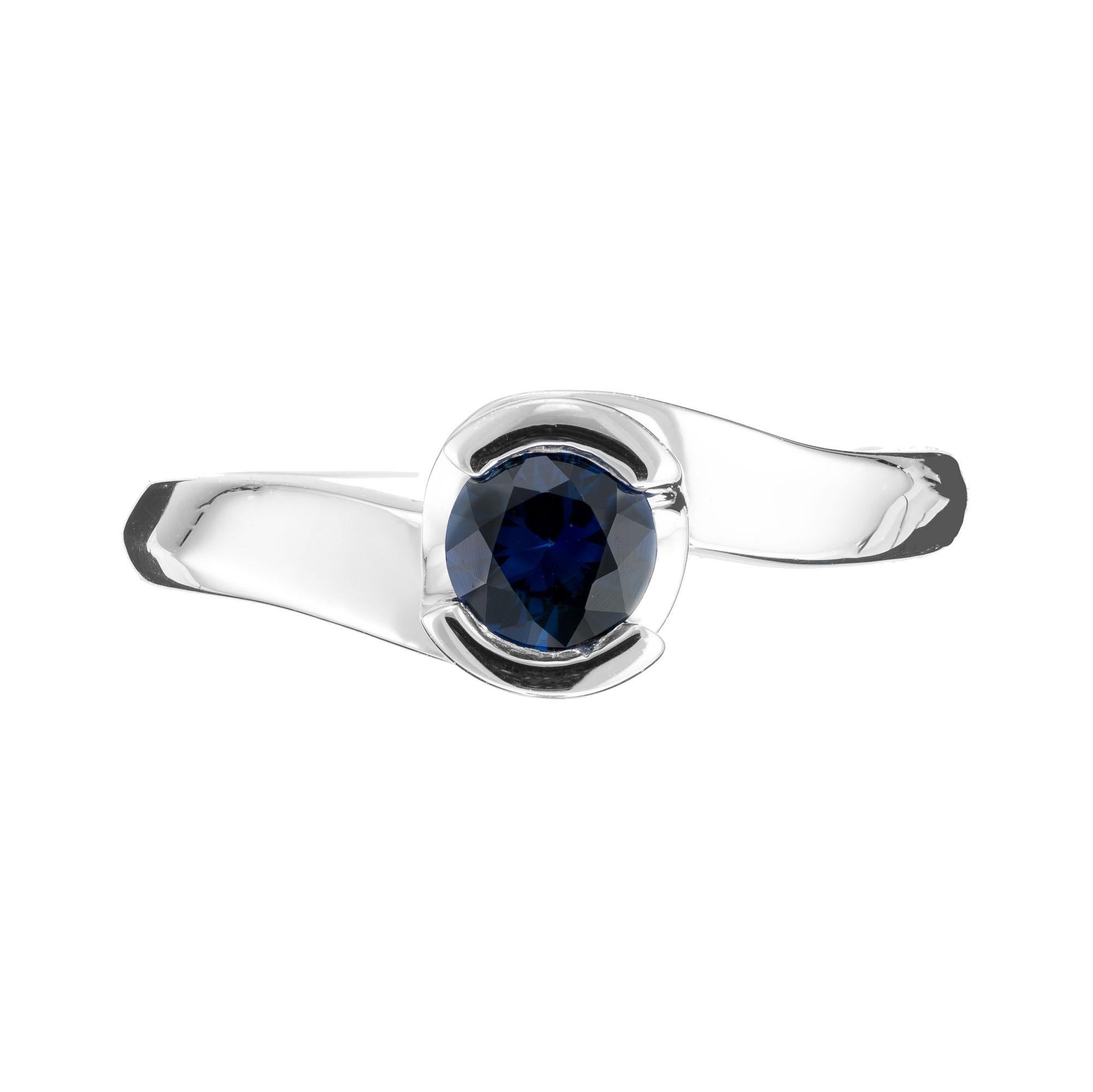 Swirl semi bezel blue sapphire ring in 14k white gold setting.   

1 Blue sapphire, approx. 65cts.  
Size 6.5 and sizeable
14k white gold
Stamped 14k
4.2 grams
