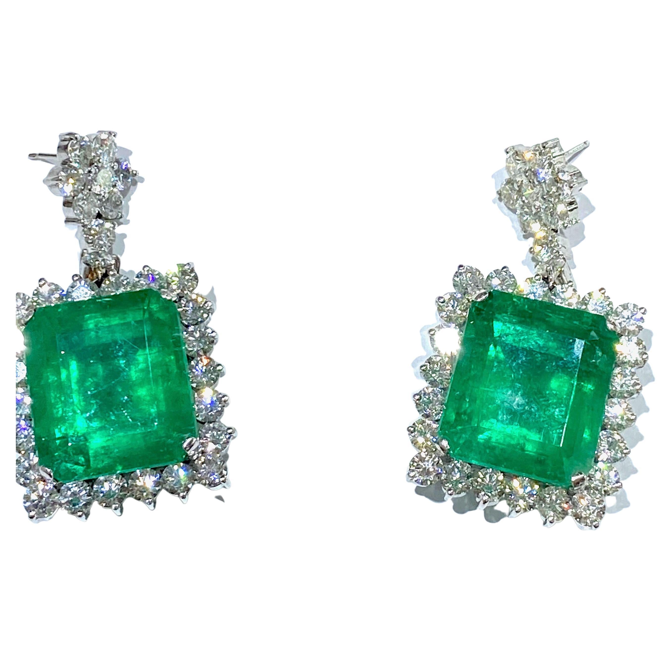 65.69 Carat Colombian Emerald and Diamond Halo Drop Earrings

Stunning, one-of-a-kind earrings are Emeralds that are weighed in at 65.69 carats. These are beautifully matched, difficult to replace, extremely large, and hard to acquire quality and