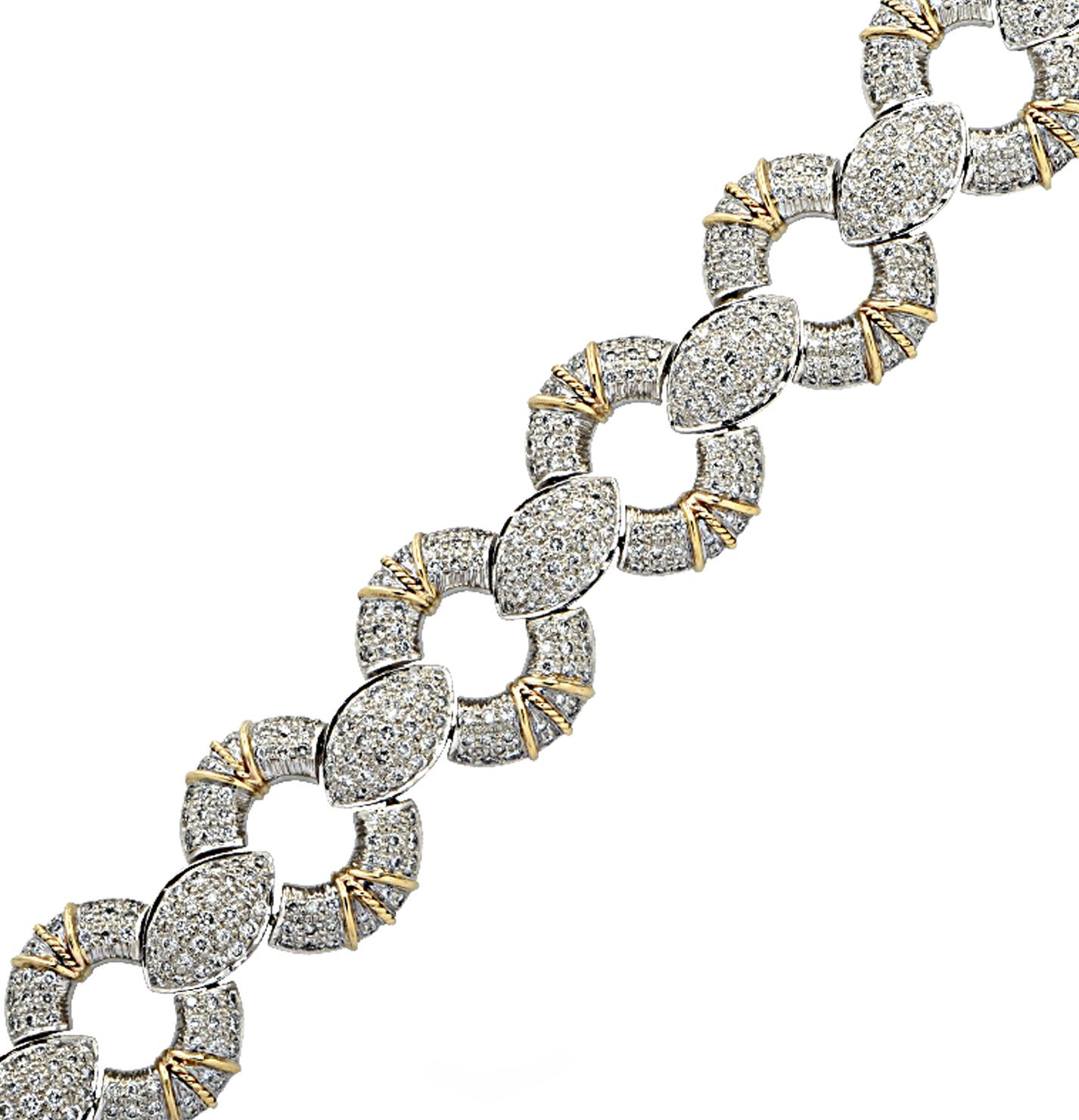 Gorgeous bracelet crafted in white and yellow gold featuring 650 round brilliant cut diamonds weighing approximately 6.5 carats total, G color, VS clarity. Open circle links, pave set with diamonds and adorned with yellow gold finishes, alternate