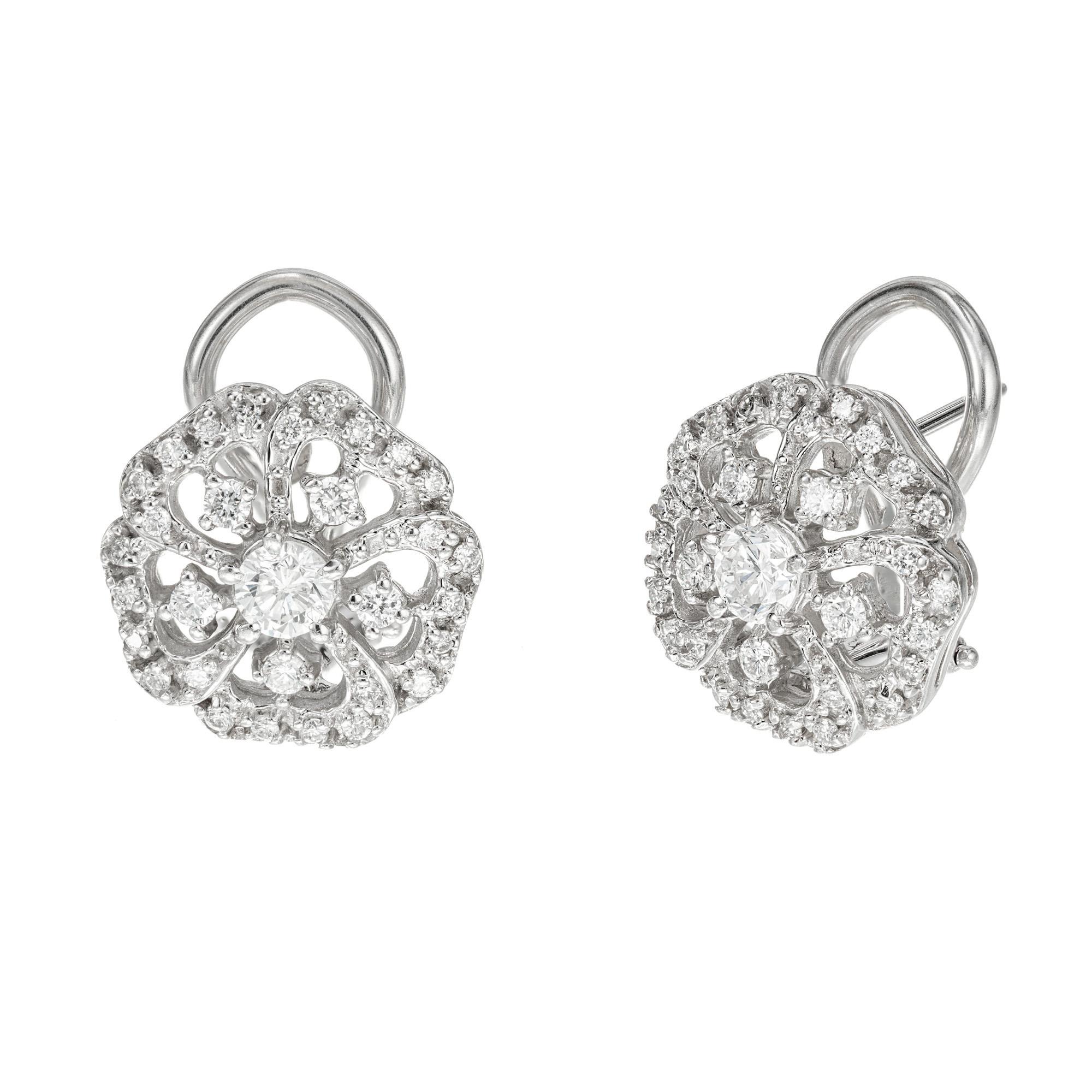 Vintage 1960's open work button style diamond earrings. 62 round brilliant cut diamonds set in 14k white gold clip post settings. 

62 round brilliant cut diamonds, G-H VS-SI approx. .65cts
14k white gold 
Stamped: 14k
6.4 grams
Top to bottom: