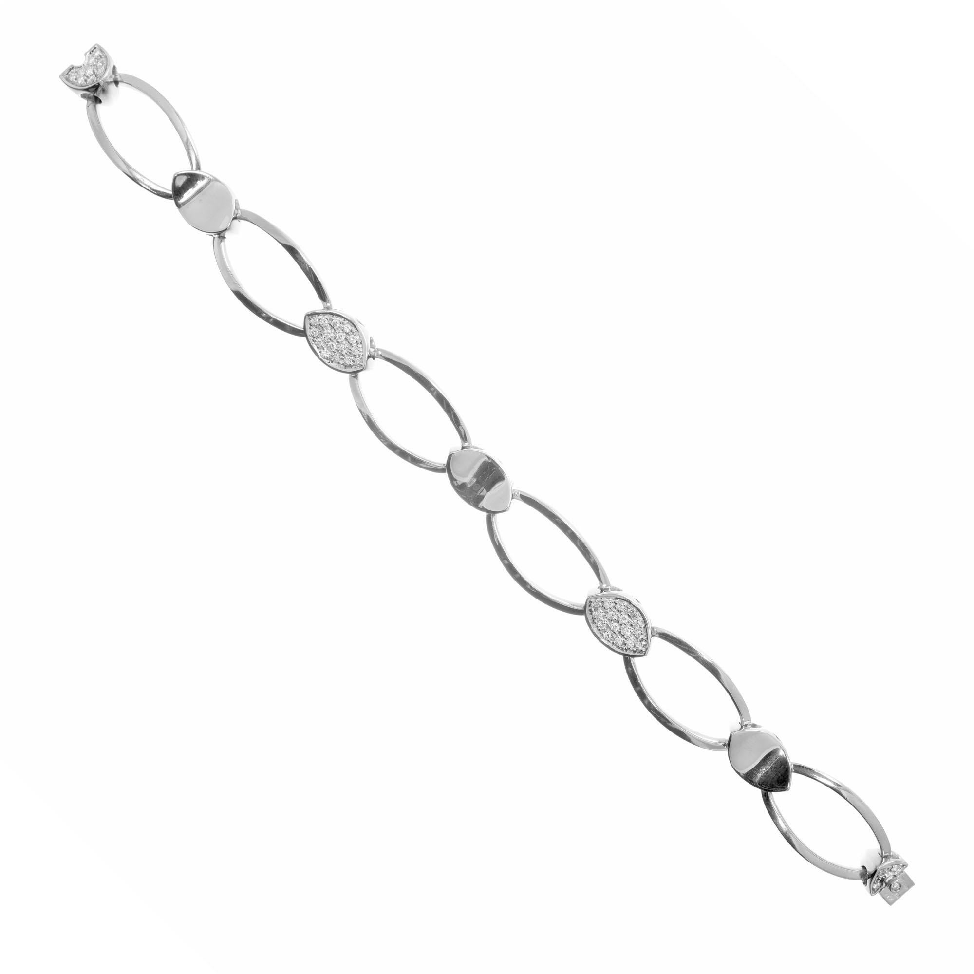 Open oval link bracelet with marquise shaped connecting links with pave set full cut diamonds in 18k white gold. 7 inches.

46 round brilliant cut diamonds, H VS approx. .65cts
18k white gold
Stamped: 750
29.5 grams
Bracelet: 7 Inches
Width: