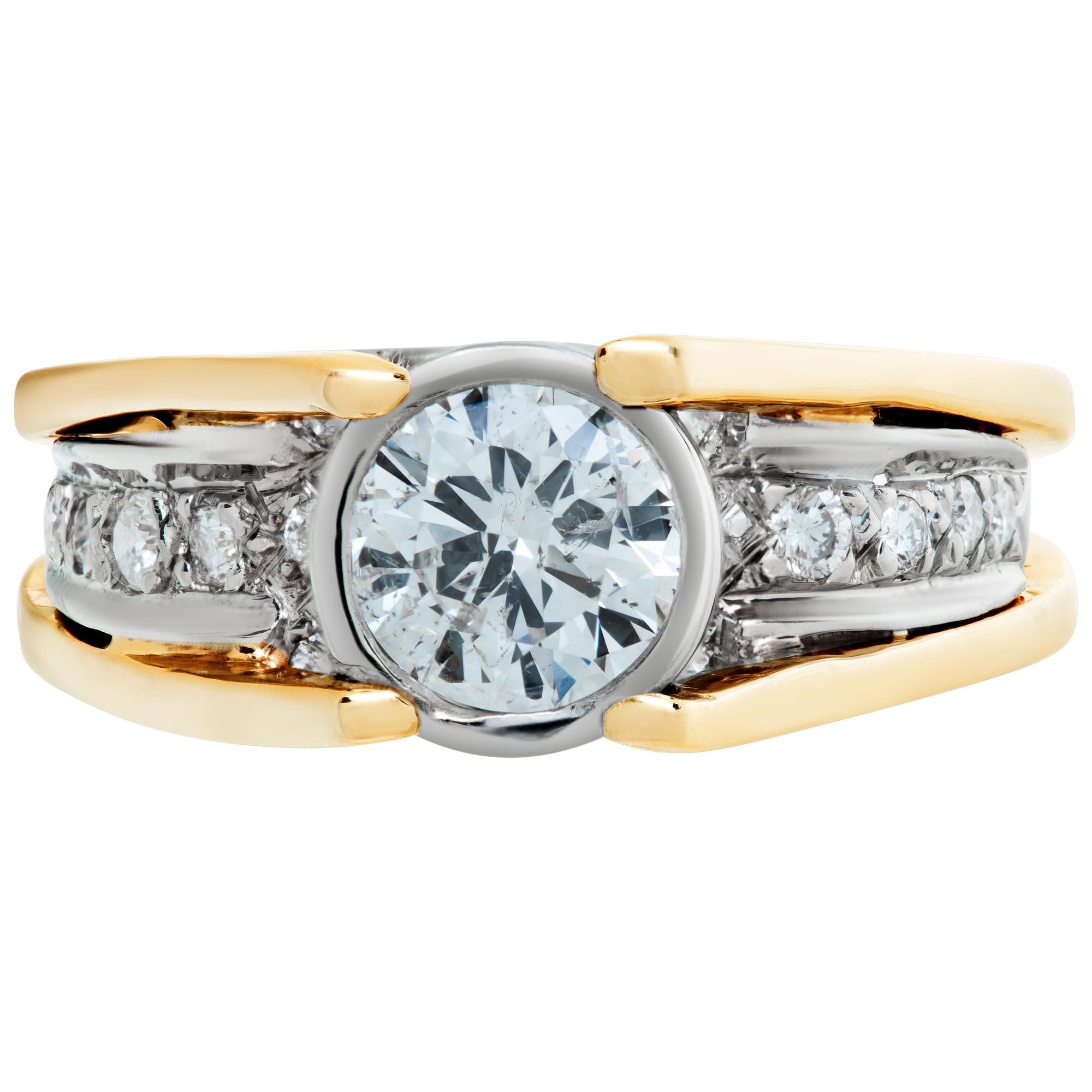Bezel set approximately 0.65 carat H-I color, SI-I clarity diamond ring in 14k white and yellow gold with 0.50 carats in G-H color, VS-SI clarity diamond accents. Size 5, width tapers 3.5mm - 7mm.This Diamond ring is currently size 5 and some items