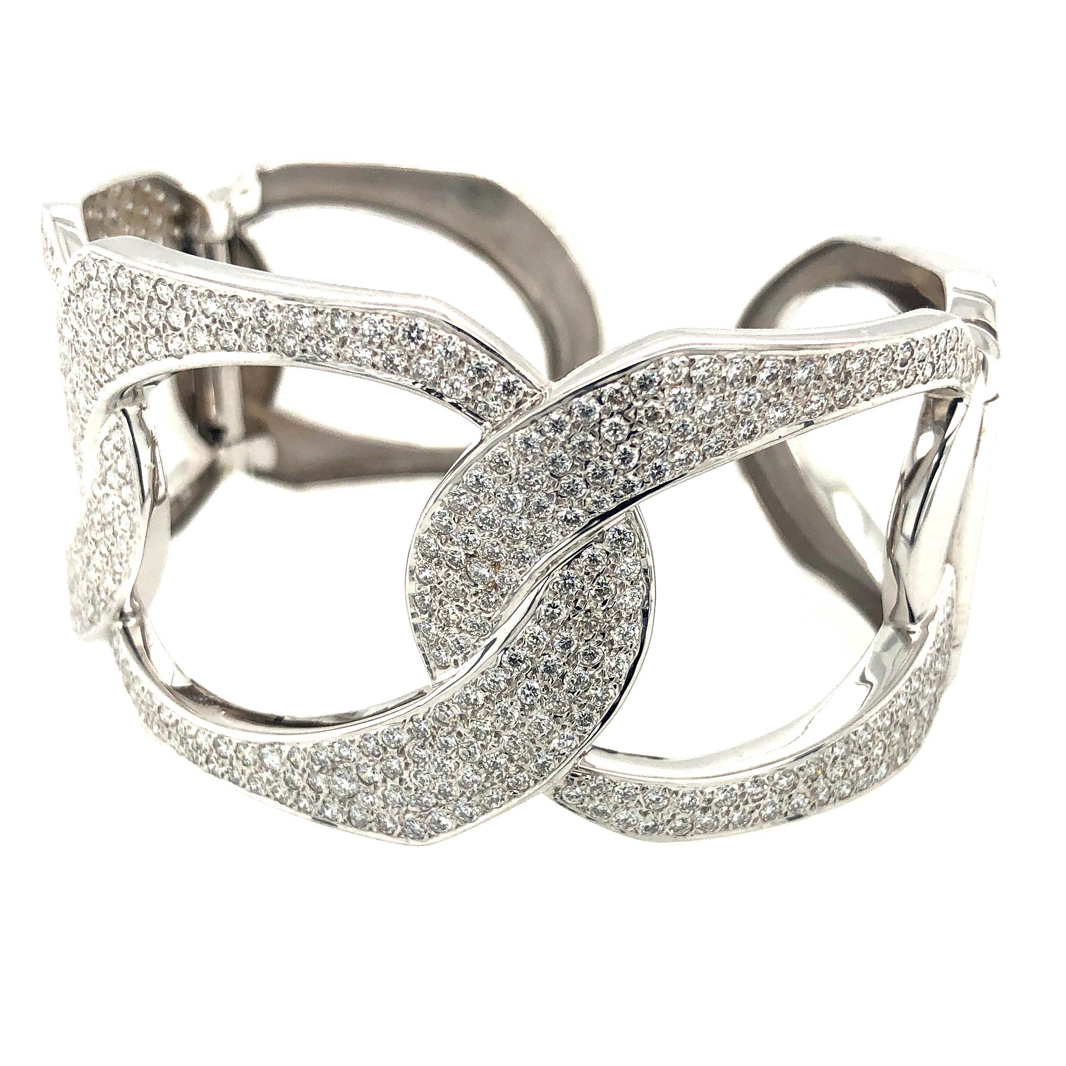  Show Source Images

Offered here is a beautiful large cuff bangle with diamonds set in white gold. The cuff has two ( 2 ) hinges so its easy to put on and take off. The cuff has natural round brilliant cut diamonds G-H color Vs2 in clarity with an