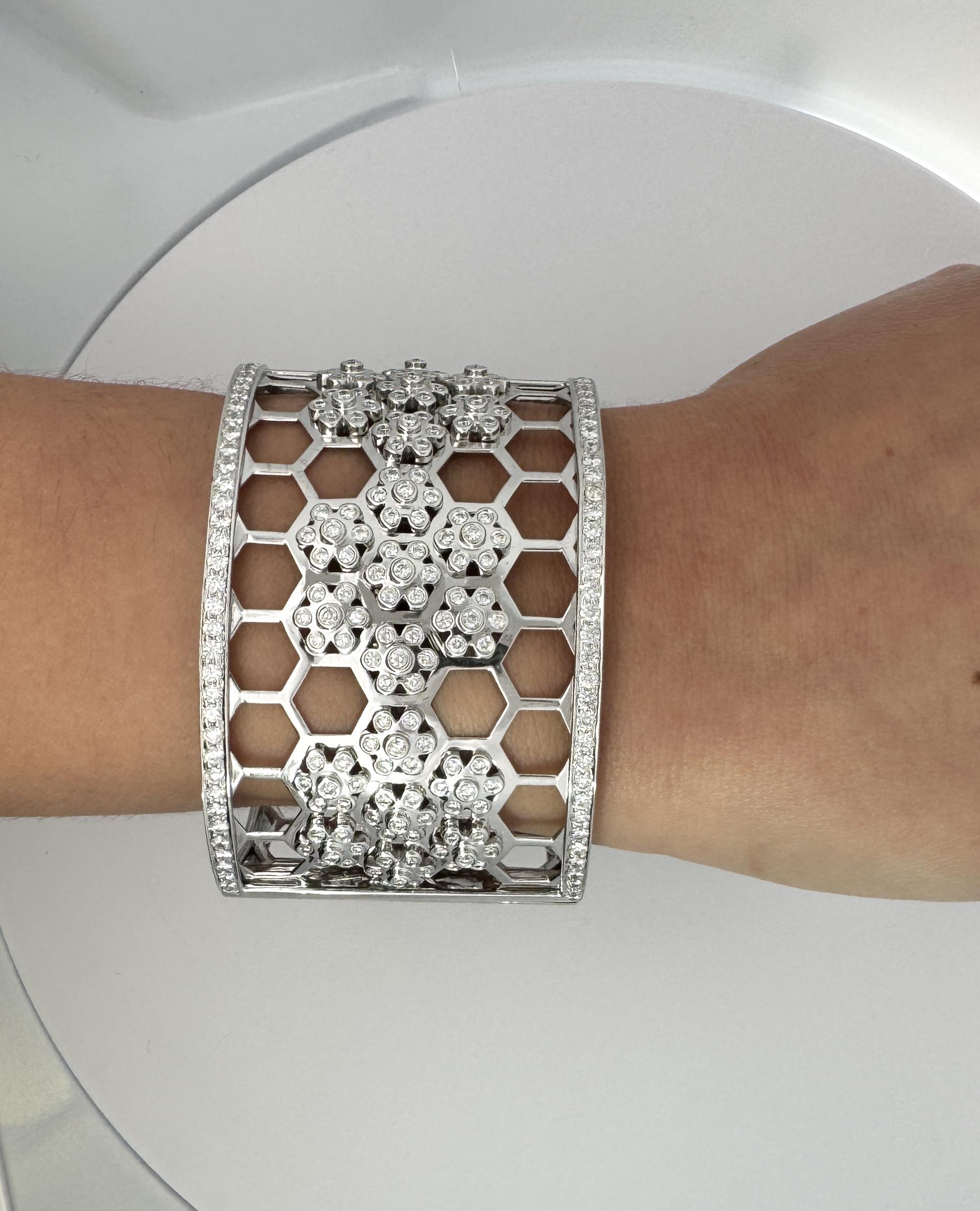 Round Cut Natural Diamond Honeycomb White Gold Bangle Bracelet. 

This bangle bracelet is crafted from white gold and features a honeycomb design throughout the entire bangle. Adorning the honeycomb design are 225 round-cut white diamonds. Each