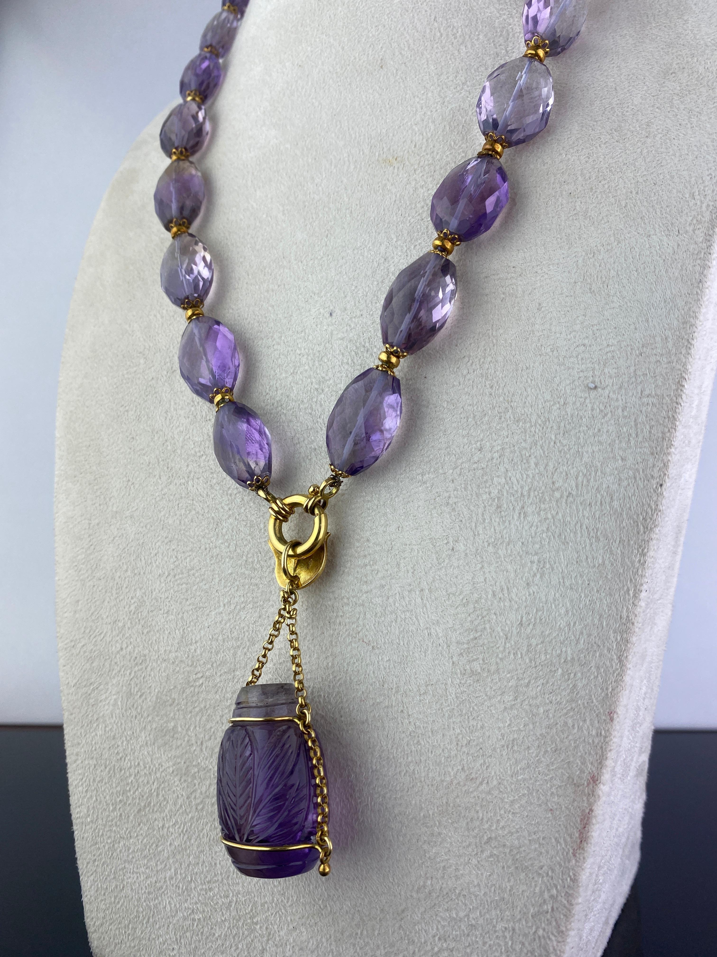 An antique 650 carat Purple Amethyst necklace, with gold. The length of the chain is 22 inches long, with a beautiful carved Amethyst pendant dropping from the necklace. 
Please message for more information. 