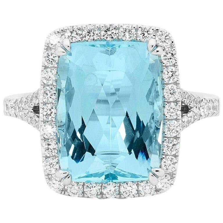 Matthew Ely 6.50 Carat Aquamarine Diamond Halo Ring, Cushion Cut Aquamarine at its center, this piece is surrounded by 0.66ct Round Brilliant Cut White Diamonds (colour F clarity VS), set with 18ct White Gold to showcase the divine hue of this