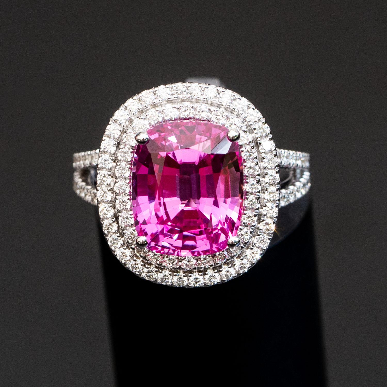 This gorgeous pink sapphire ring will impress everyone around you. It features a large cushion 6.50 carat gemstone, adorned with 1.08 carat natural diamonds.

Sapphire
Shape: Cushion
Mineral: Natural Corundum
Hardness: 9 on Moh's scale
Carat: 6.50